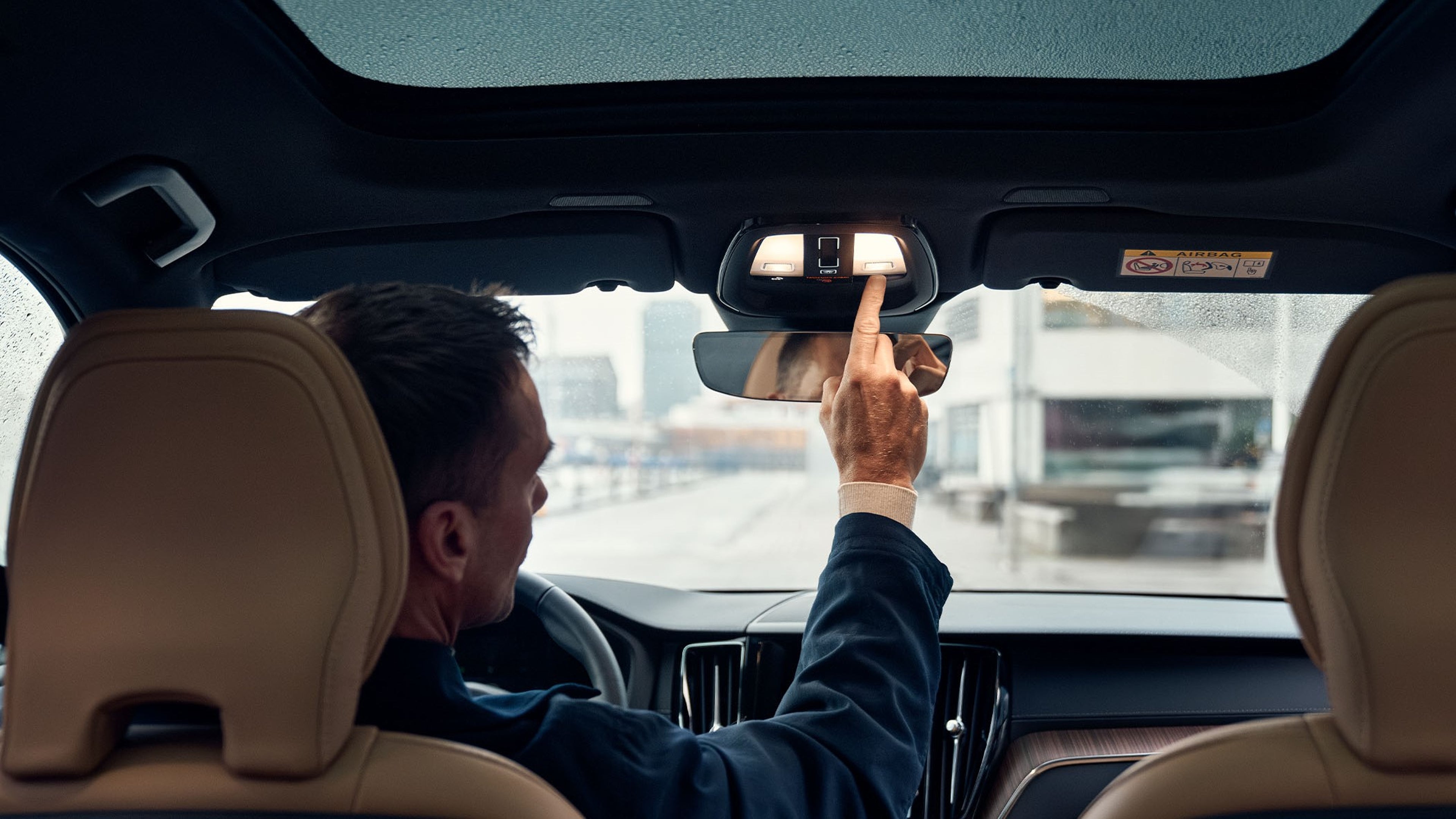 Pressing button in overhead console in Volvo