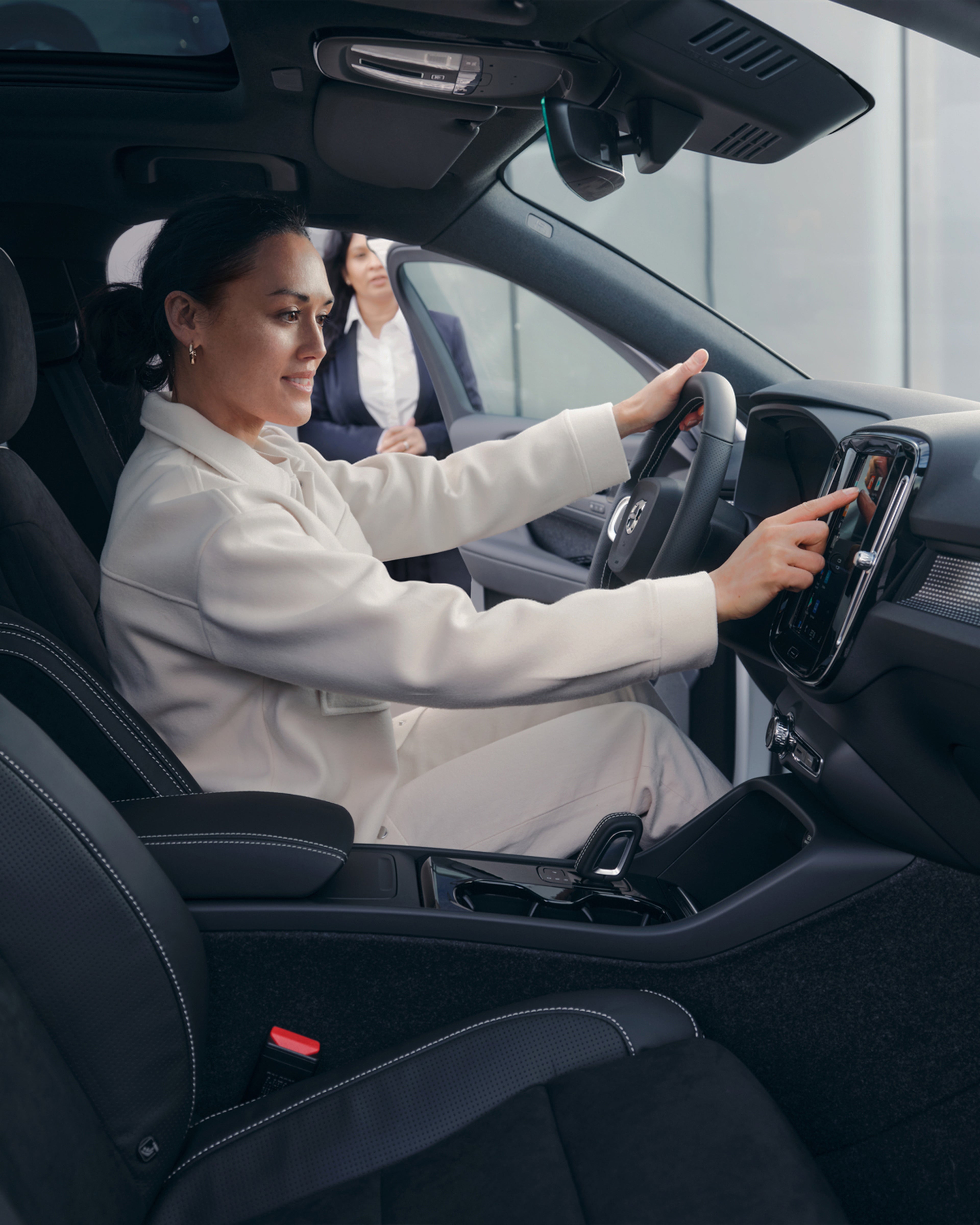 Una mujer al volante de un vehículo Volvo.