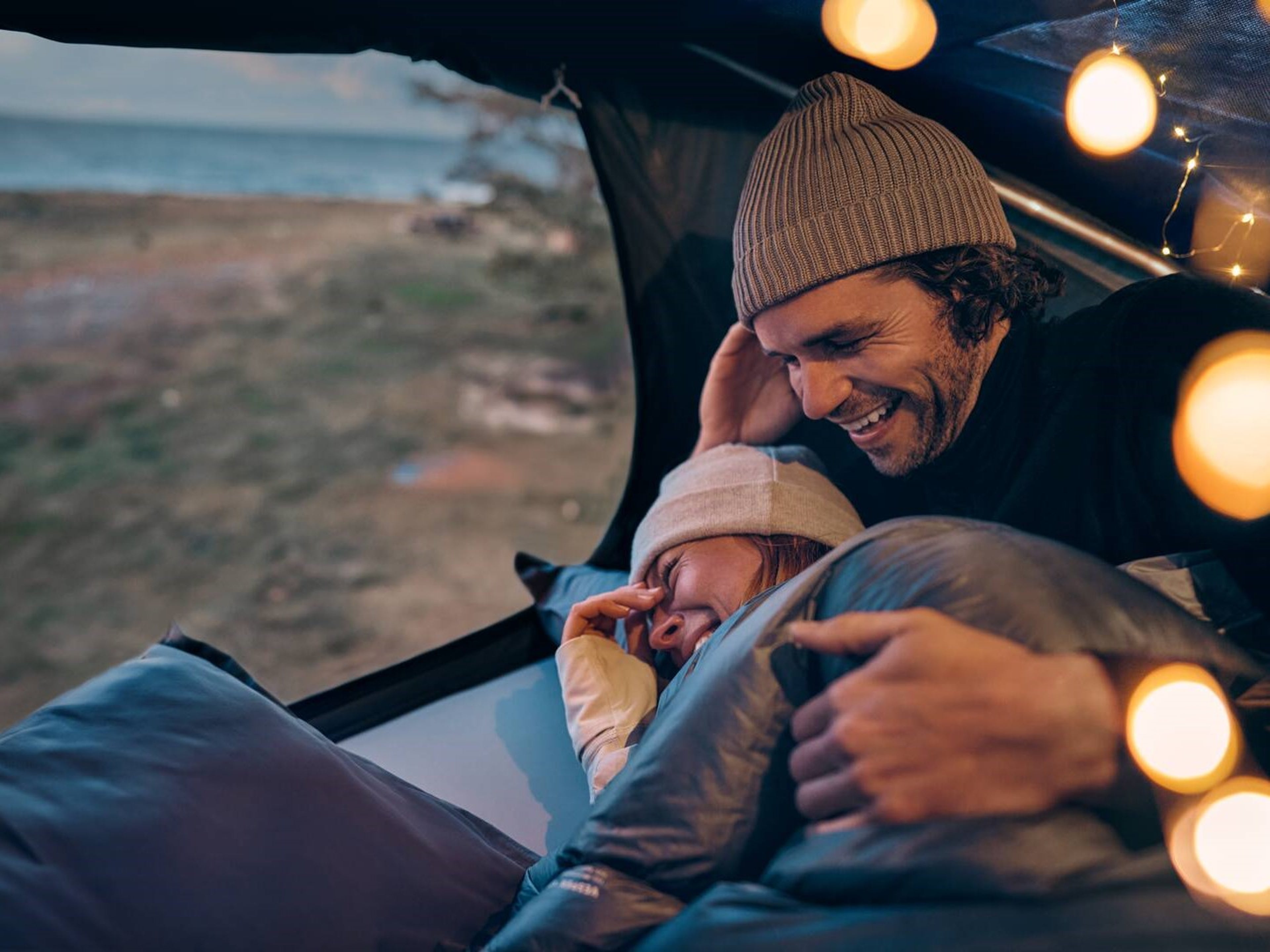 People in a rooftop tent in a Volvo