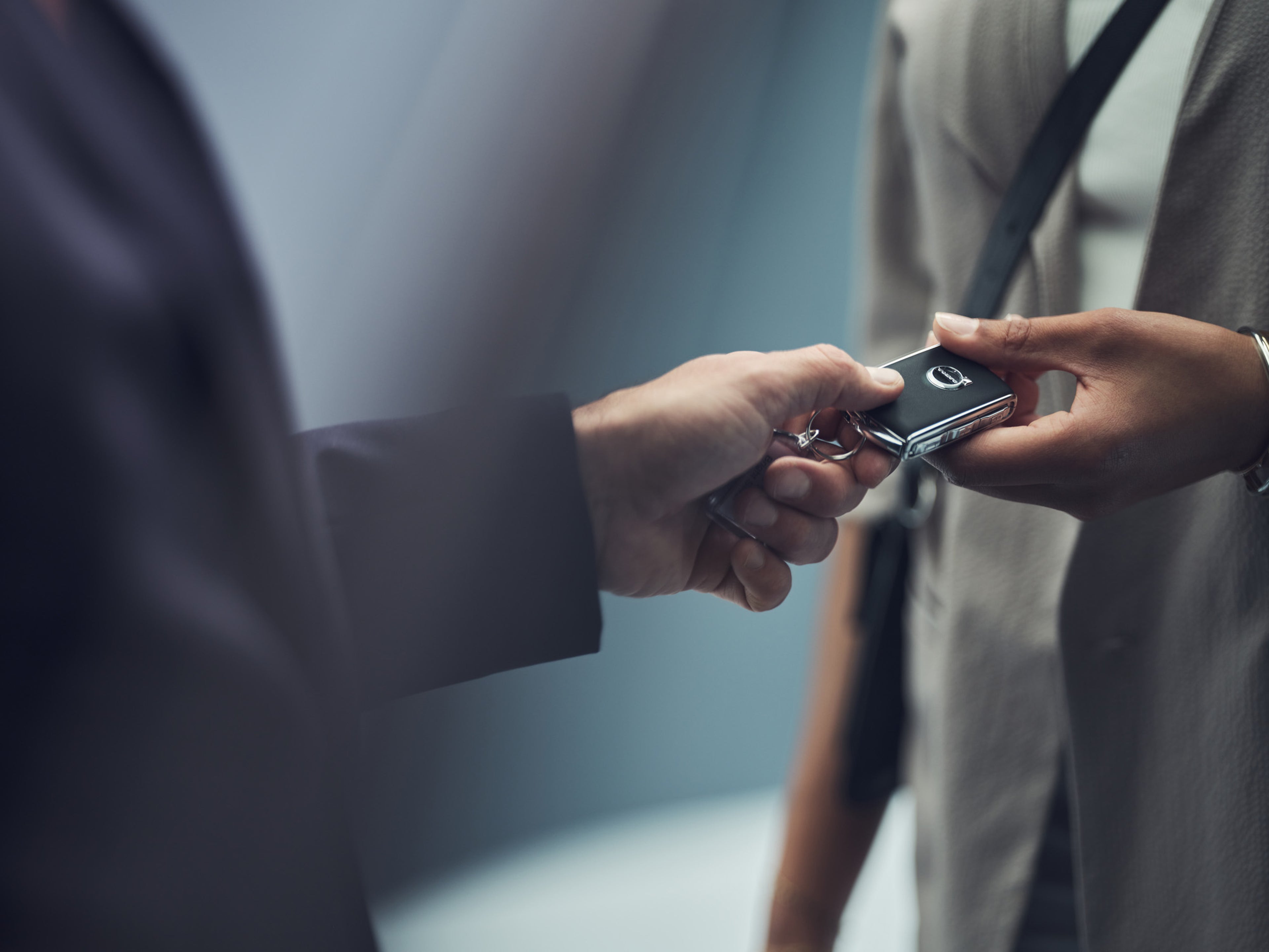 Person handing a technician a Volvo key fob