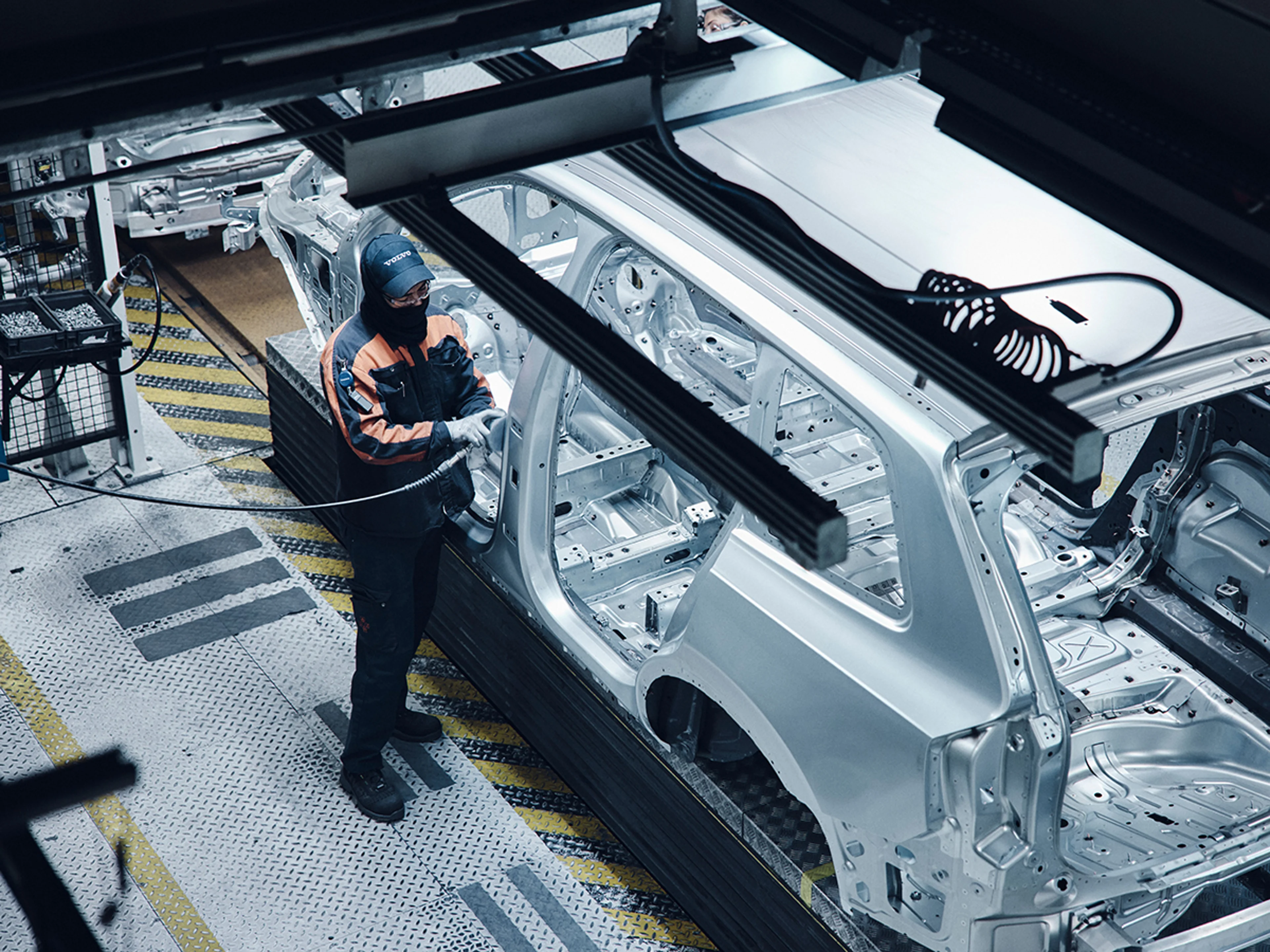 Volvo Factory Tour - Overseas Delivery - Man building a car in a factory