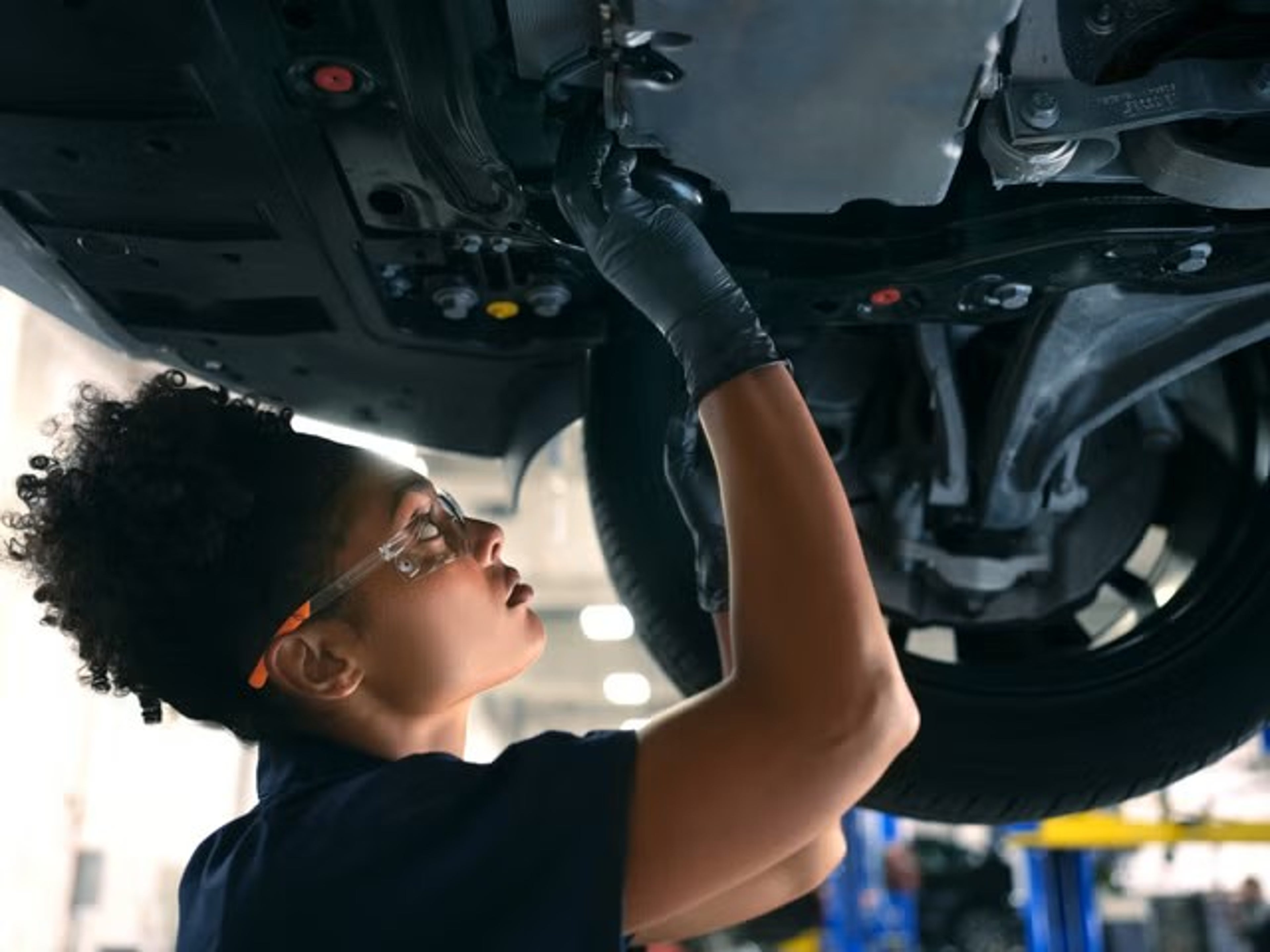Volvo technician working under car