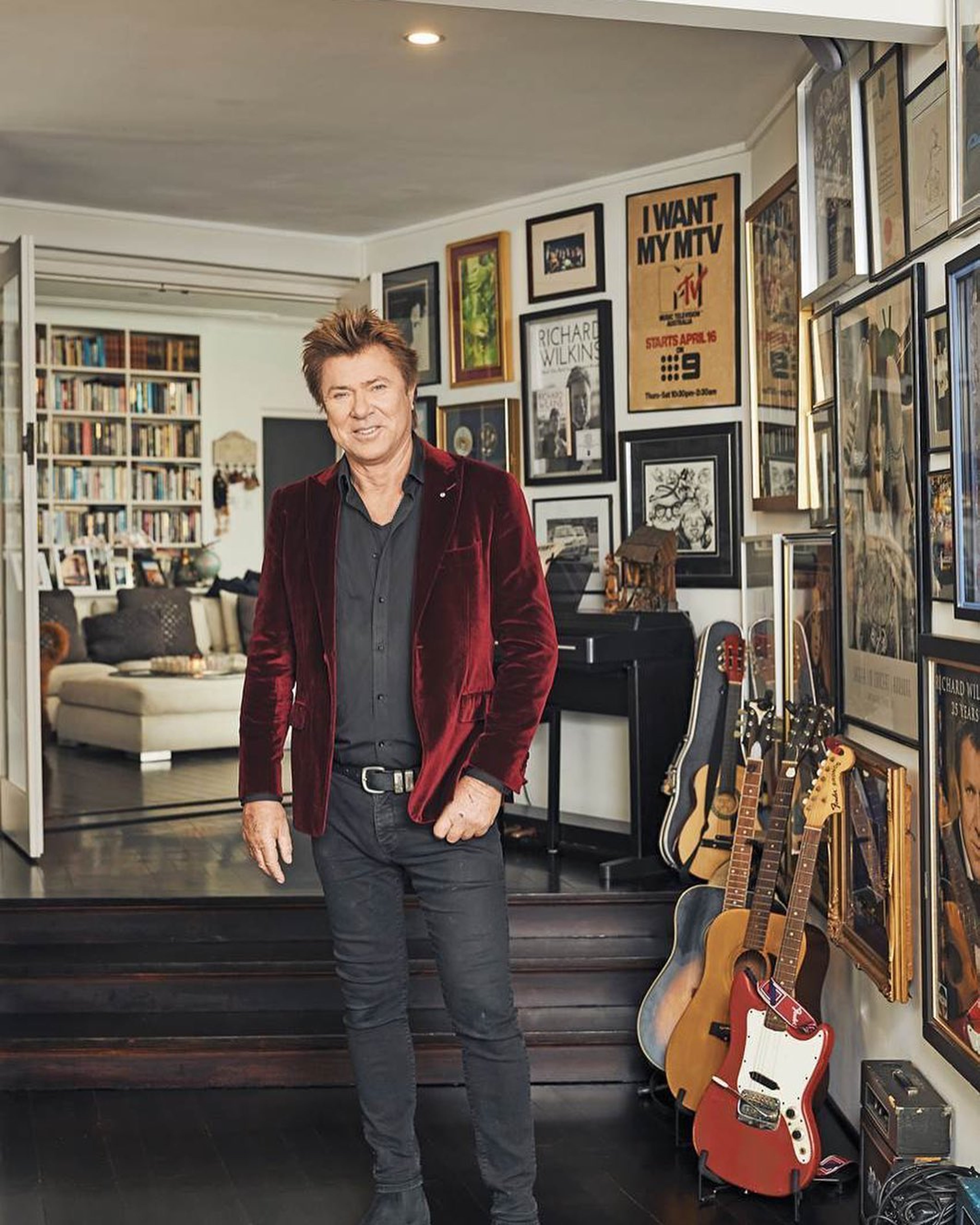 Richard Wilkins standing in front of guitars