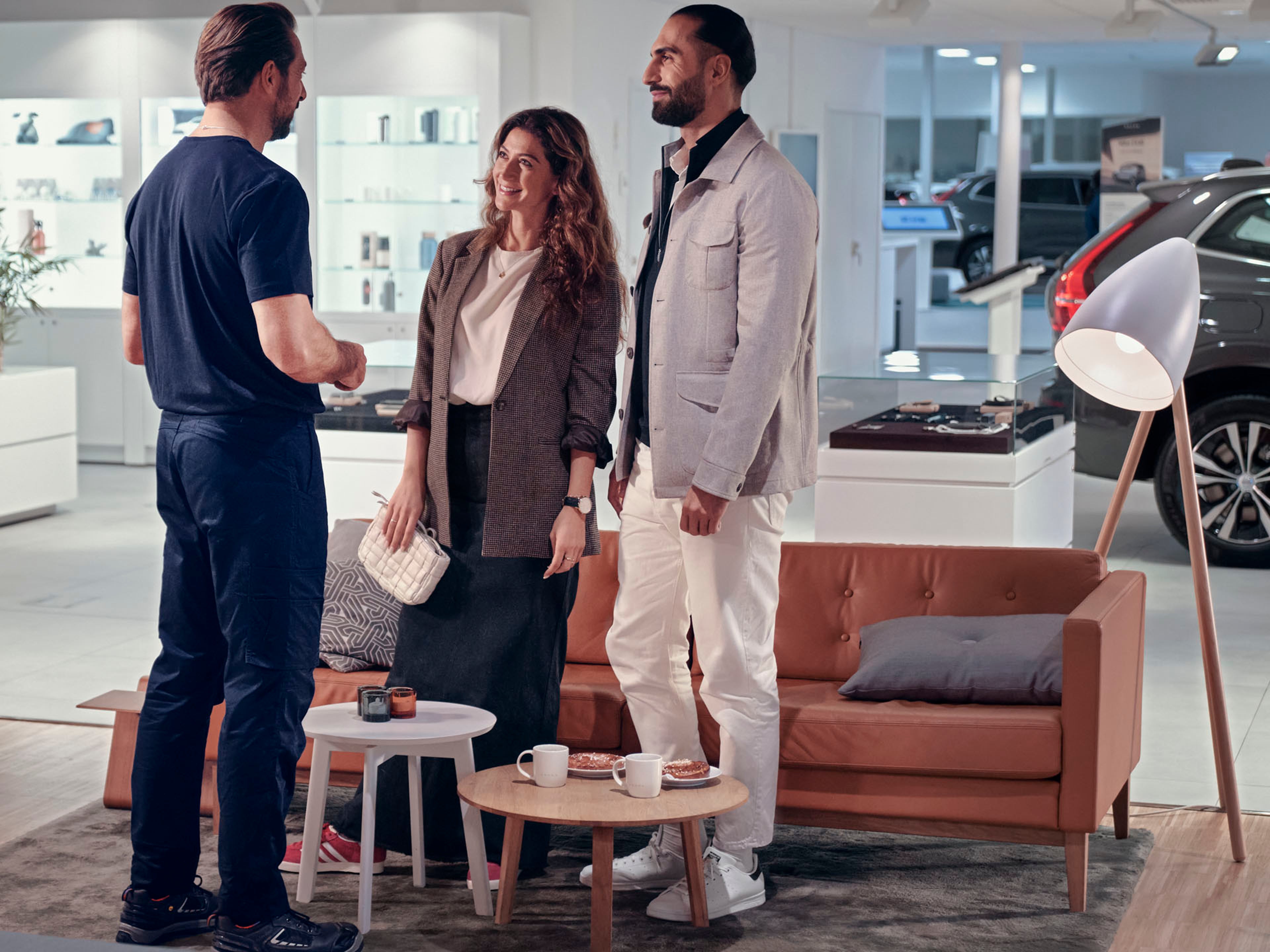 Un concesionario Volvo y una pareja de clientes conversando con su especialista personalizado