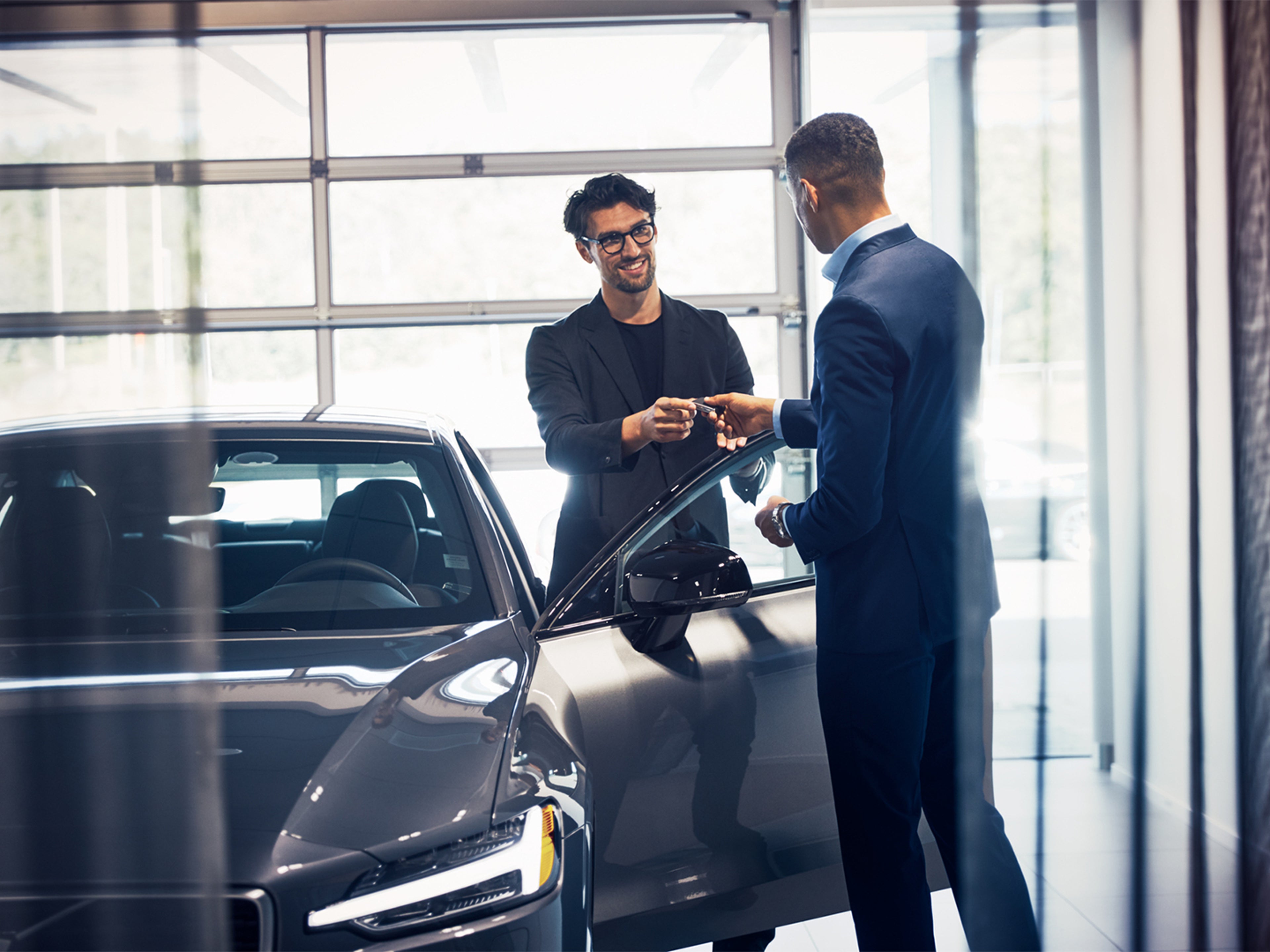 Incentive for Participation - Volvo In-Use Verification - Two people standing by a car