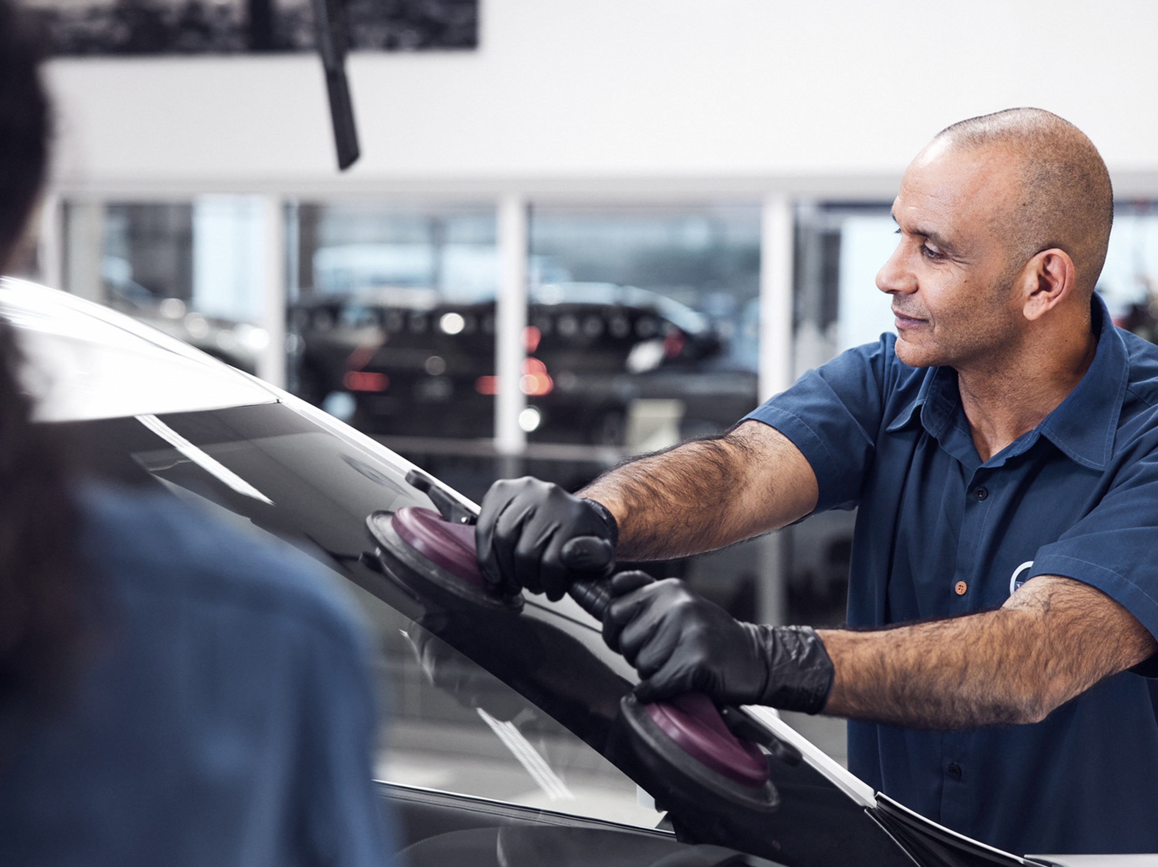 Tecnico Volvo a colcocar um para-brisas, vista fora do automóvel