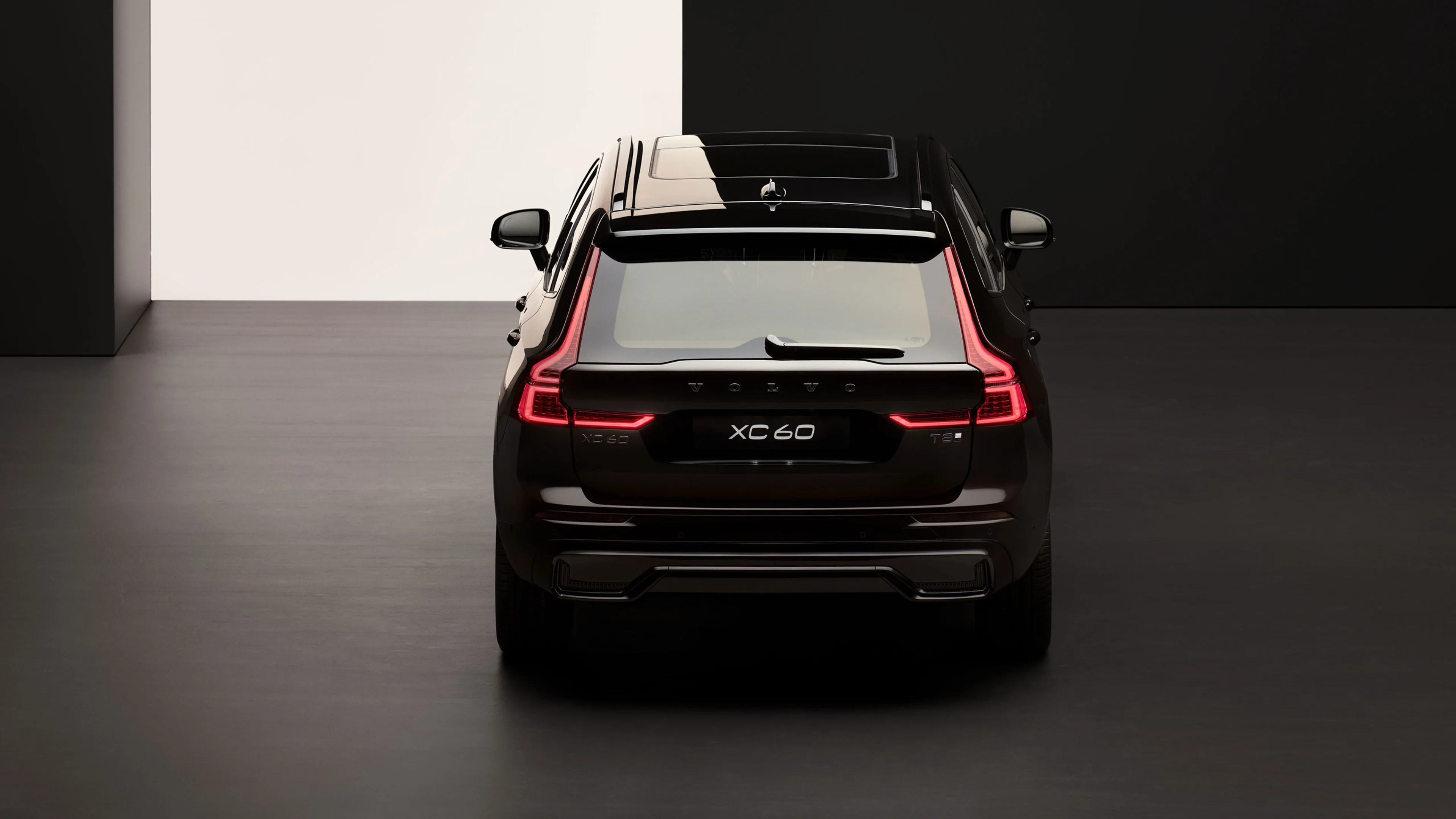 Vue arrière d'un Volvo XC60 Black Edition, avec feux LED en forme de L, et toit ouvrant vitré.