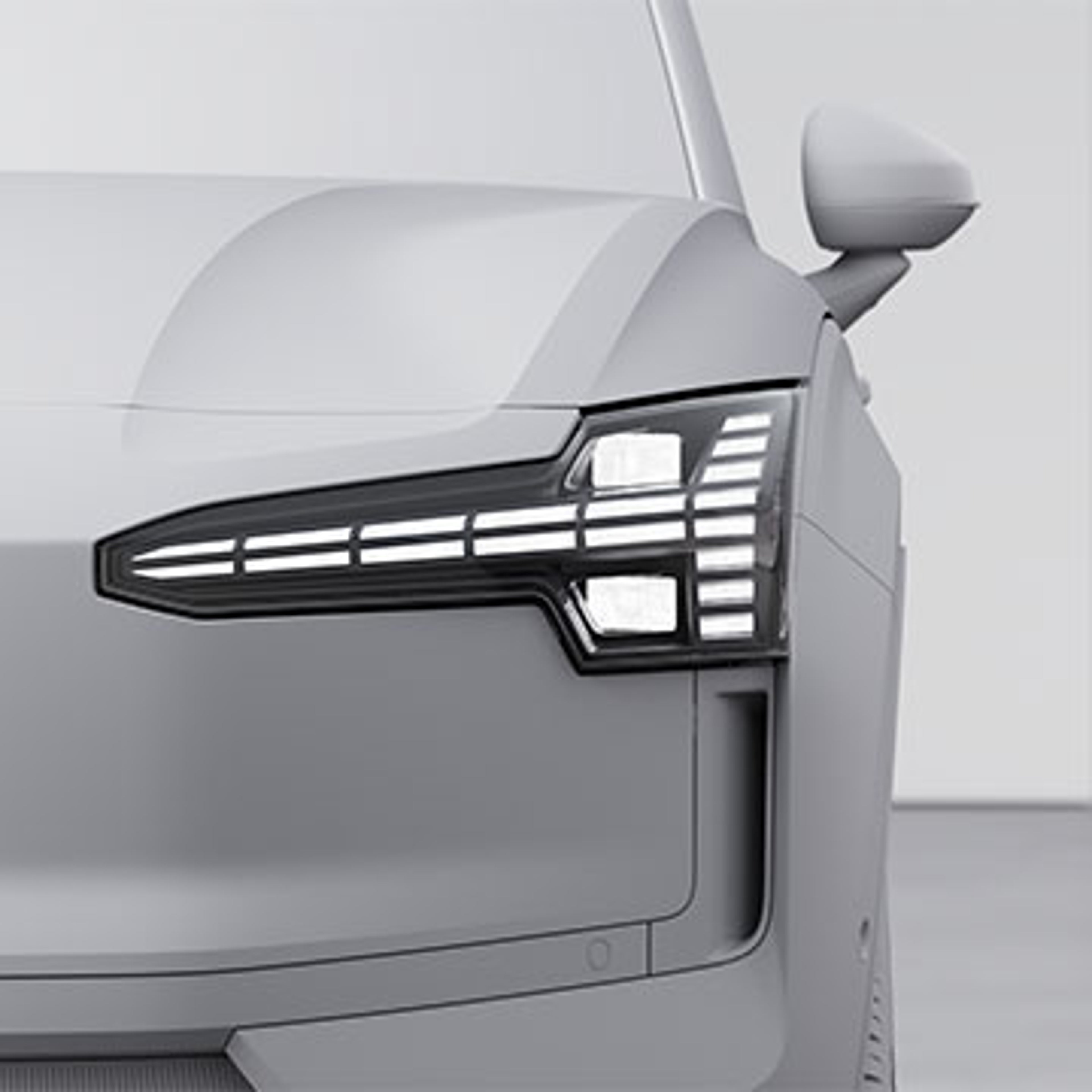 Phare avant droit d’une voiture Volvo EX30 moderne avec LED distinctives et design angulaire.