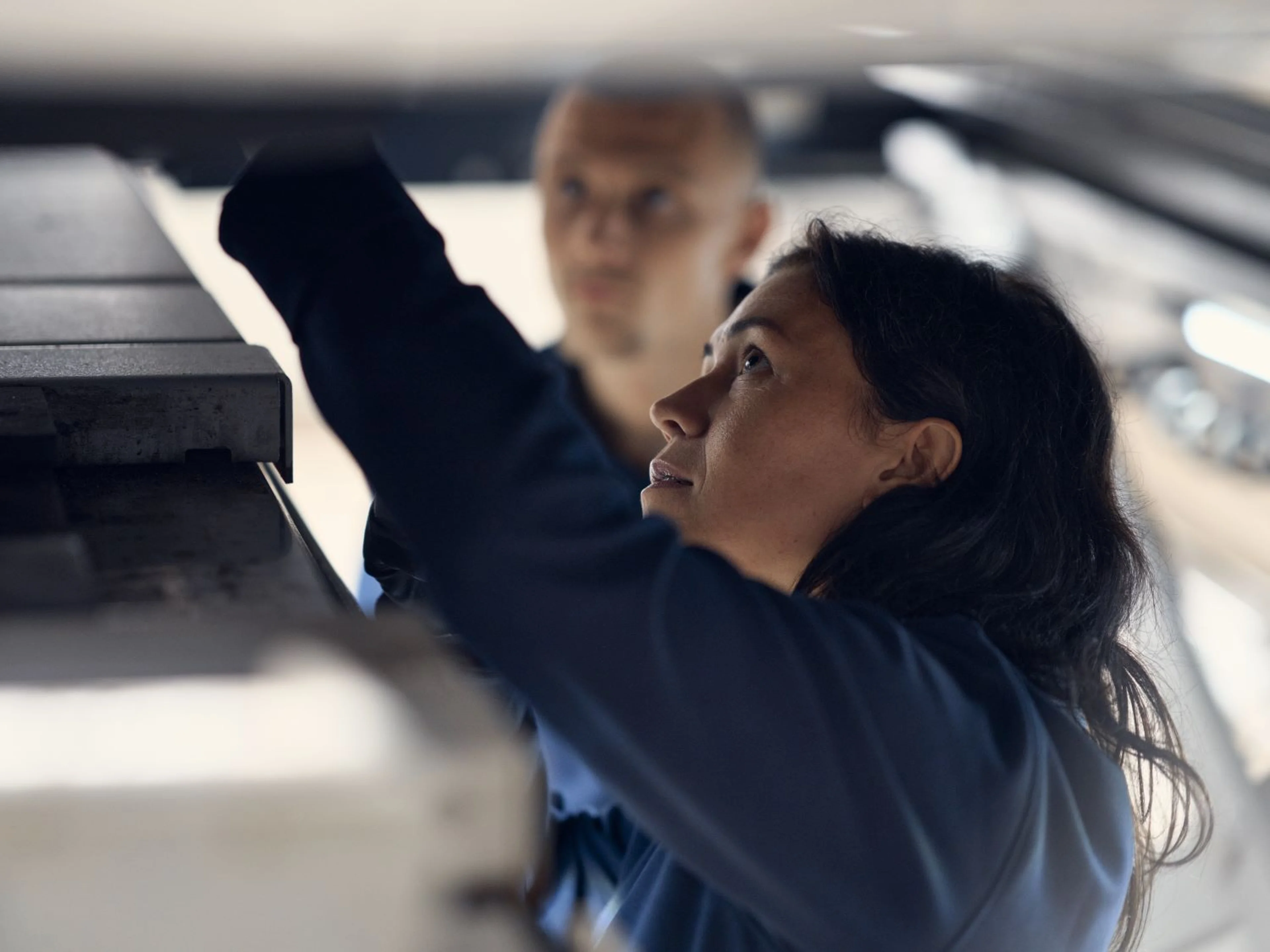 Volvo Technician looking under Volvo