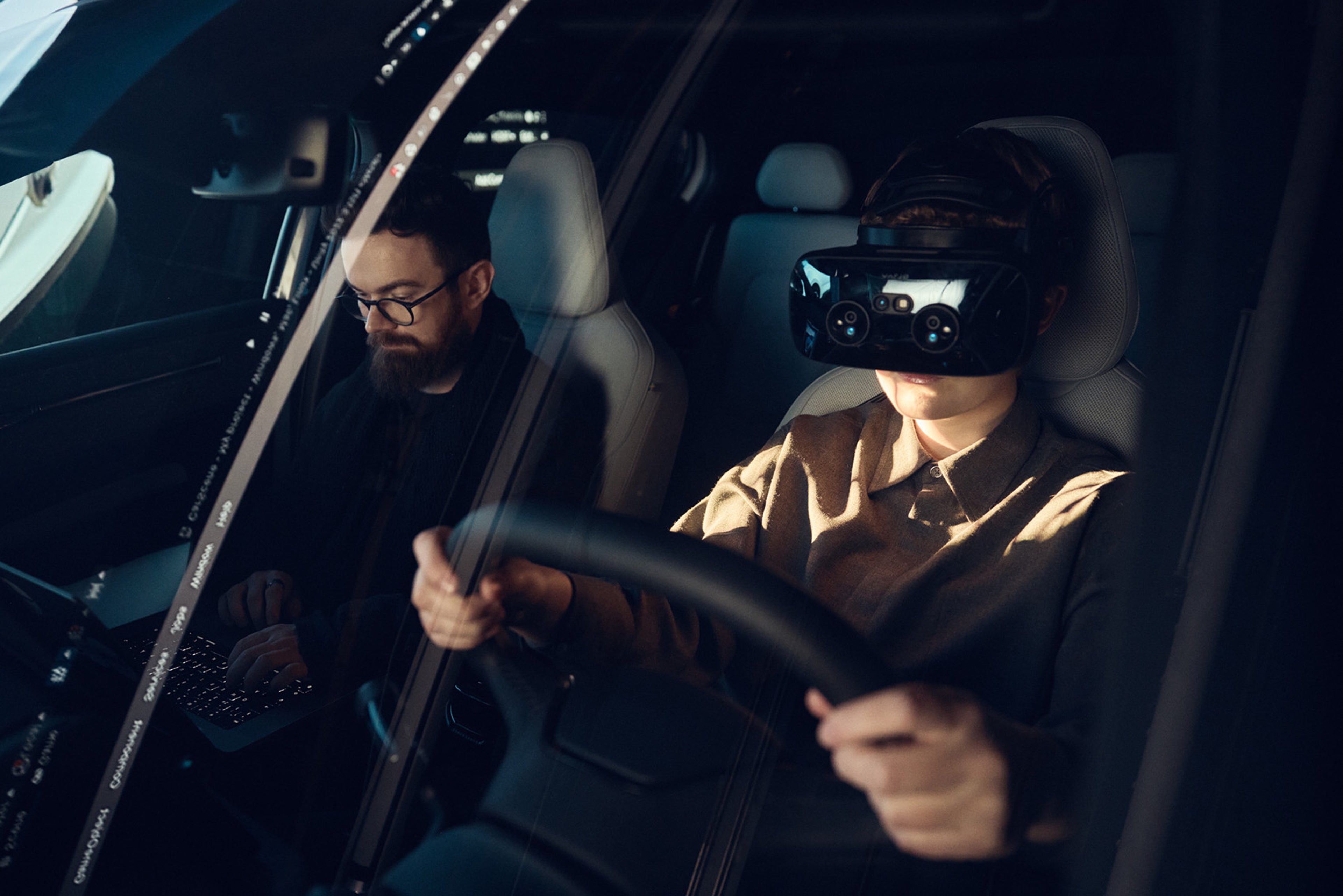 A woman in a pink jacket smiling at someone or something