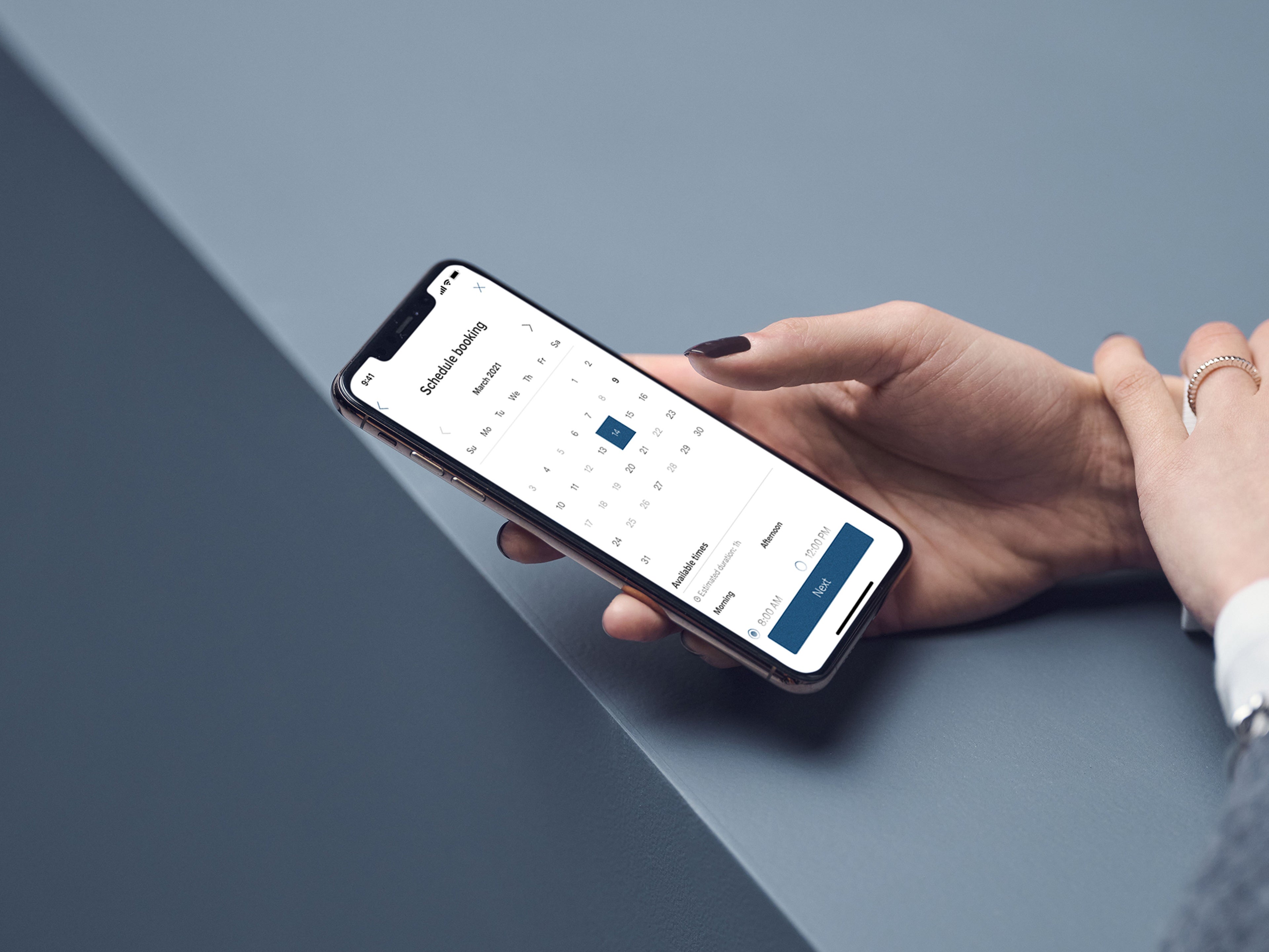 Person using Volvo Cars app to schedule service