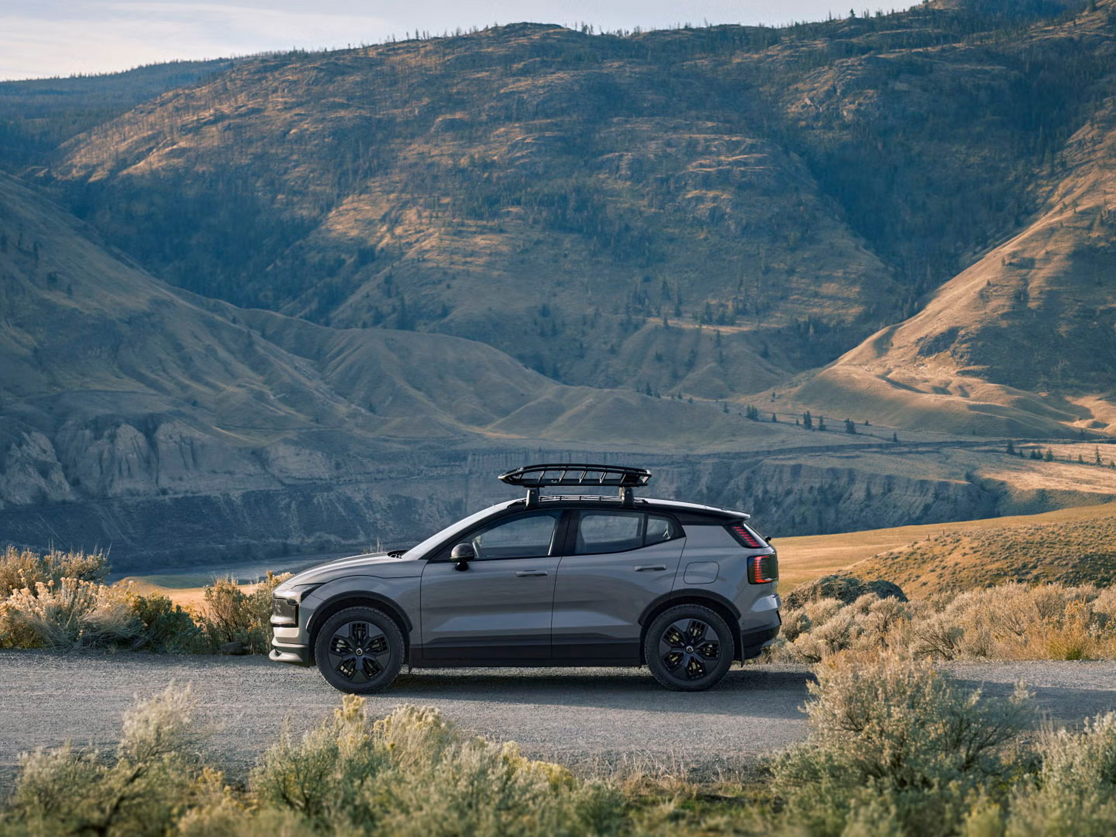 Side view of EX30 Cross Country with large mountain range in the background