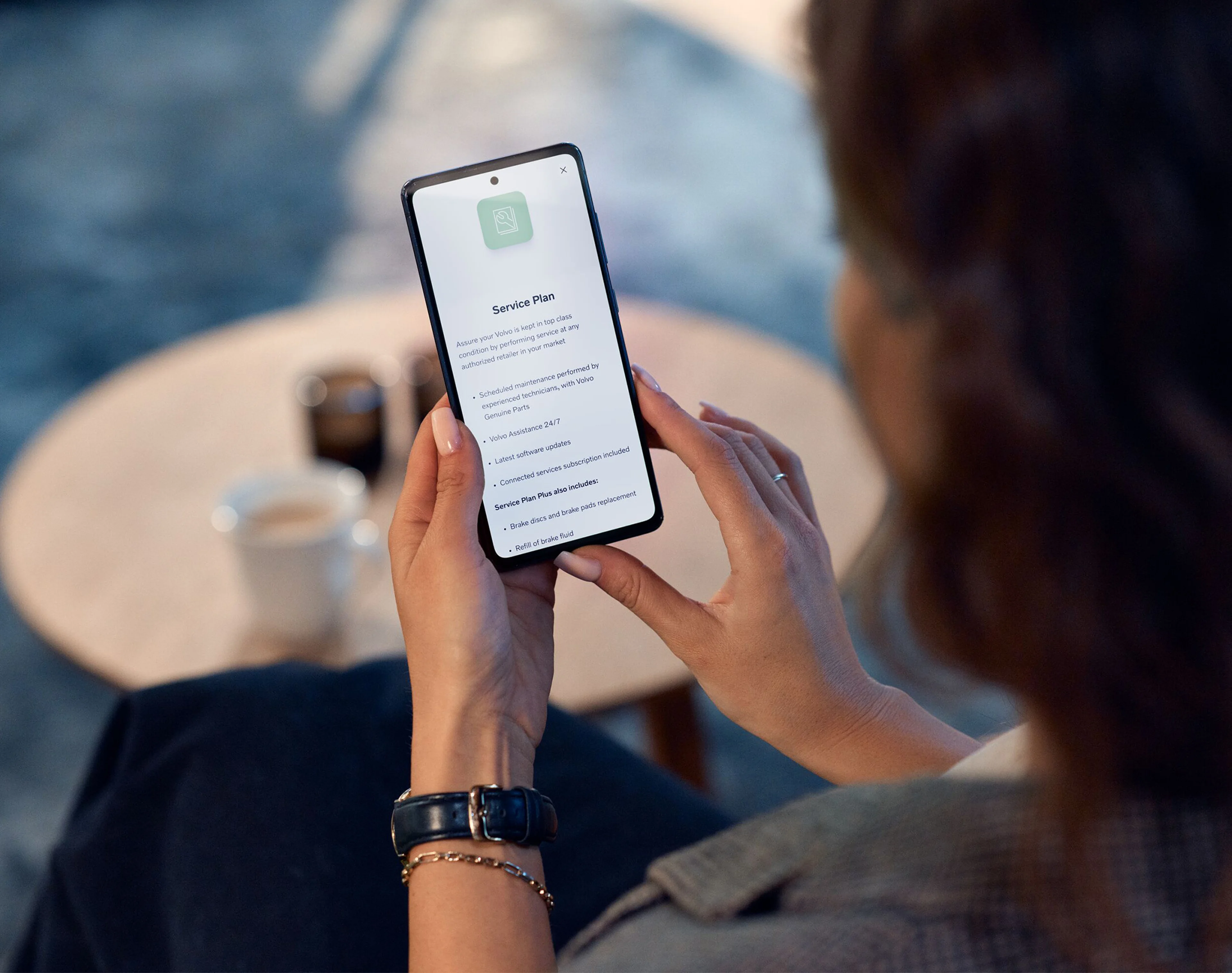 Volvo Cars App - person using app on mobile device