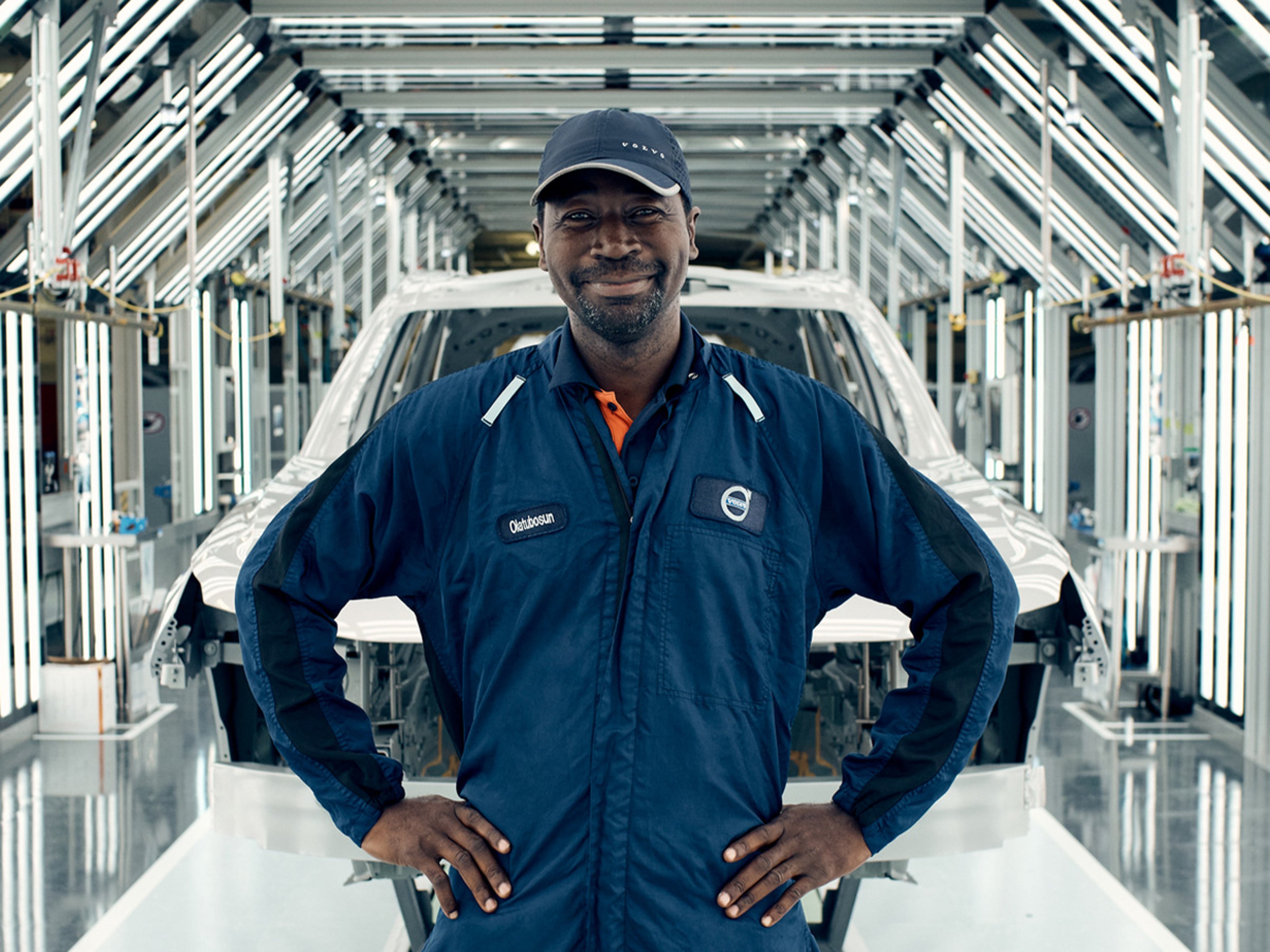Man standing in front of partially assembled EX90 in the Volvo South Carolina Factory