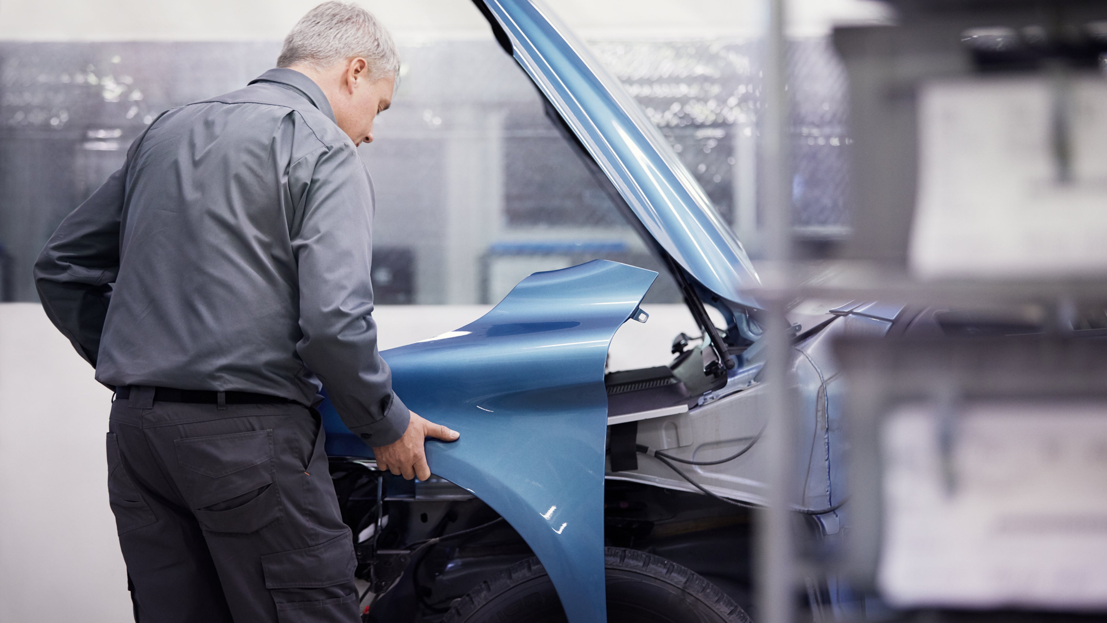Person removing side panel from car