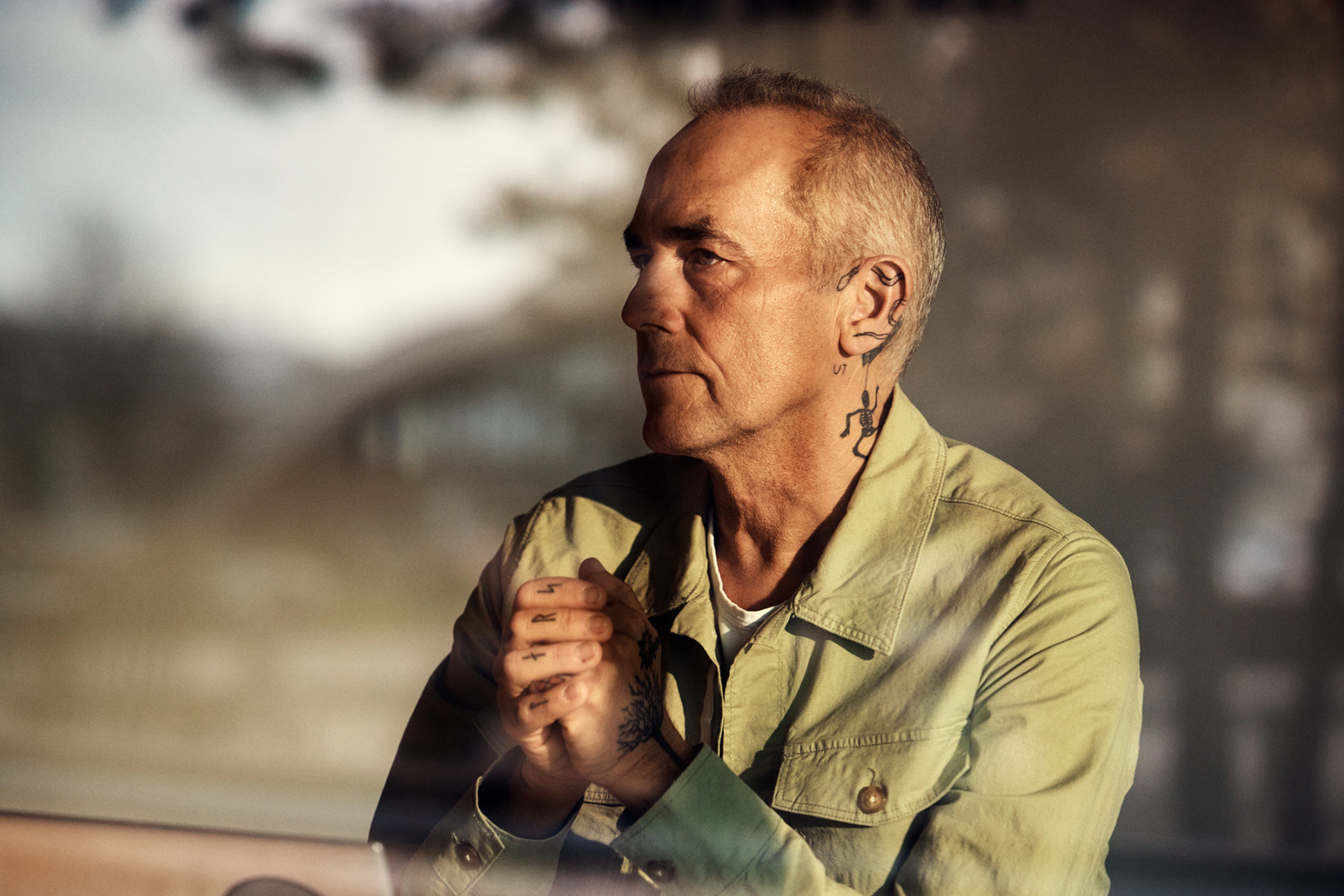 A woman in a pink jacket smiling at someone or something