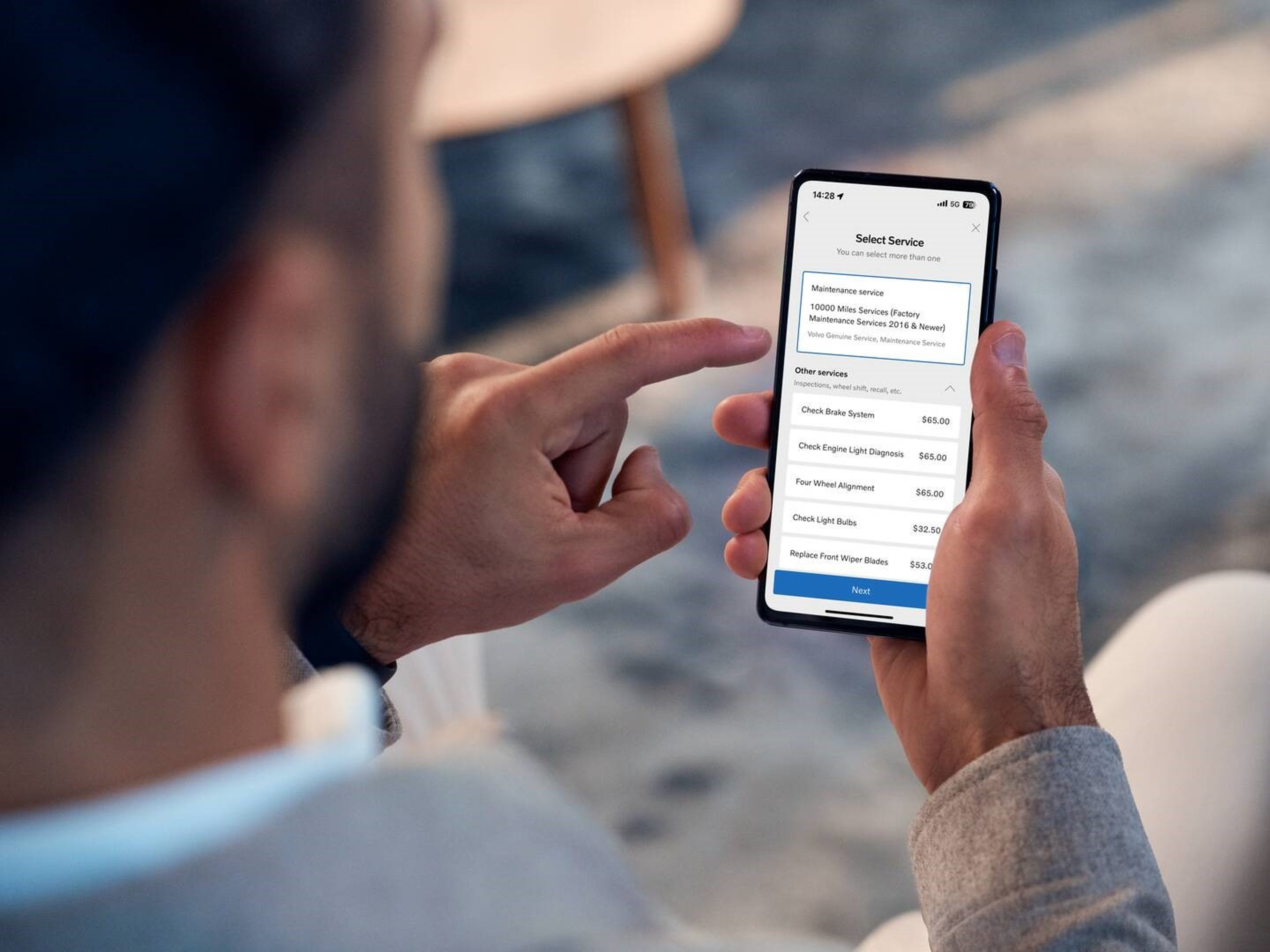 Volvo Cars App - person using app on mobile device