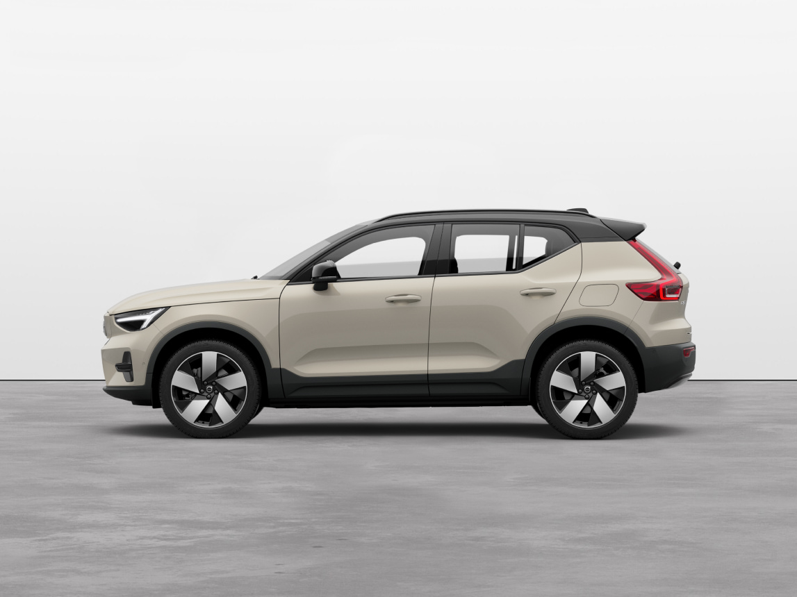 Volvo EX40 full electric compact SUV standing still on grey floor in a studio