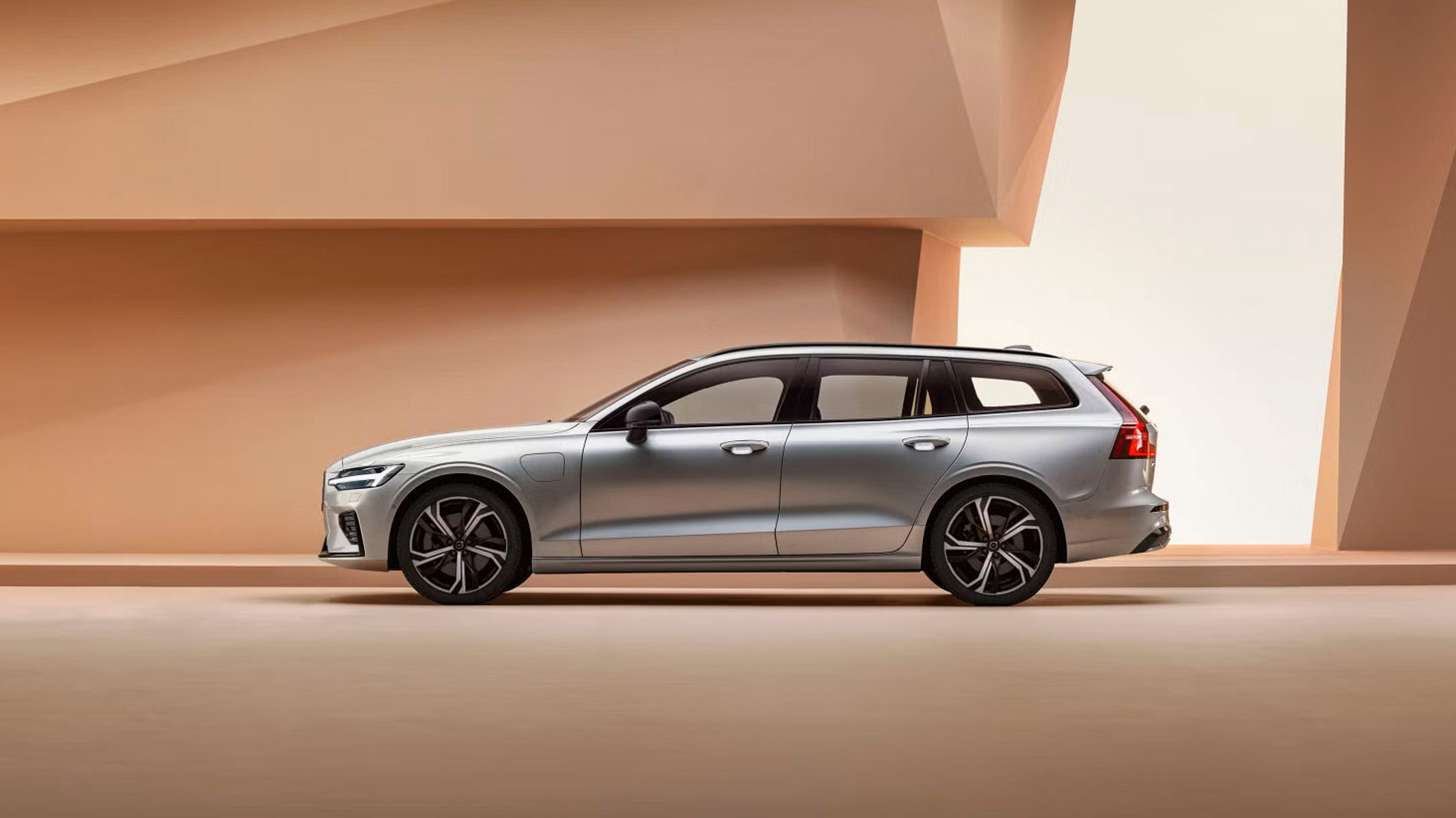 Side view of V60 plug-in hybrid against pastel geometric background