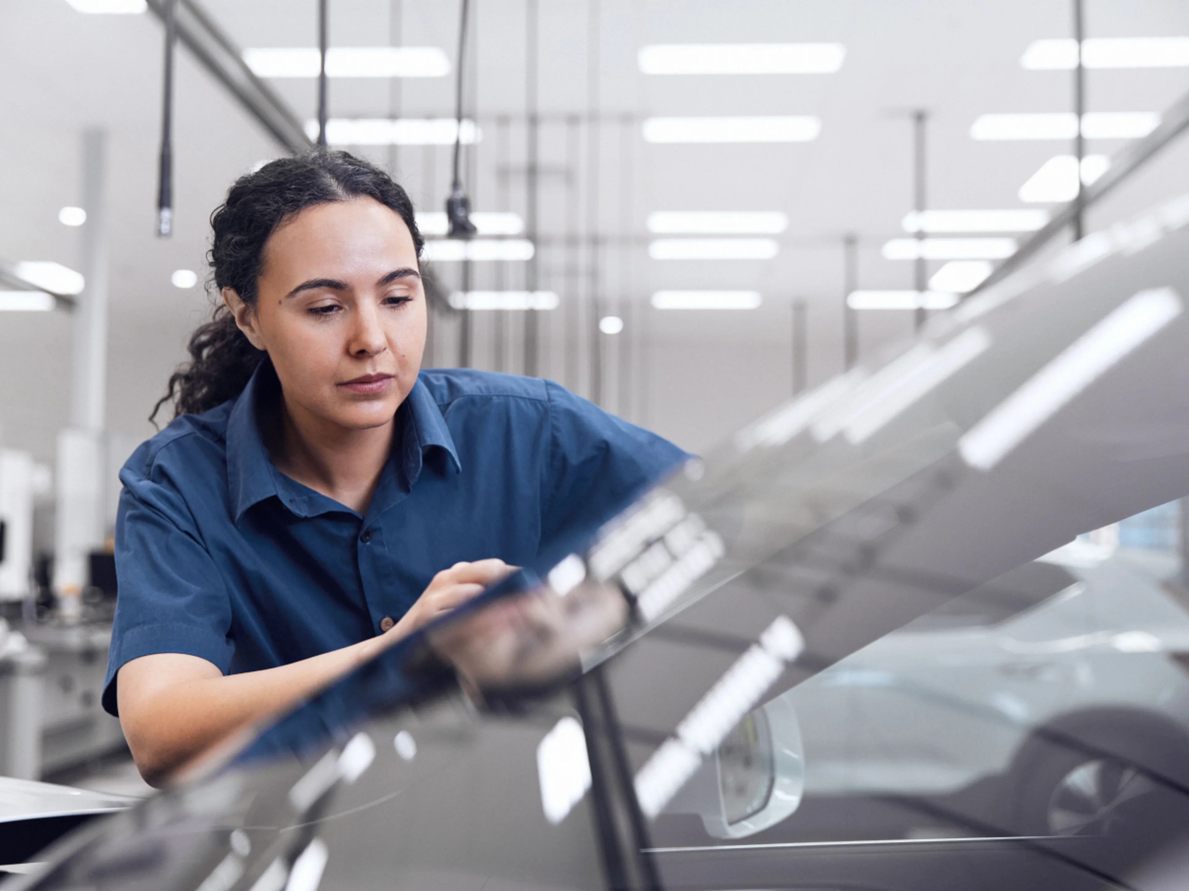 Volvo service technician inspecting the car.