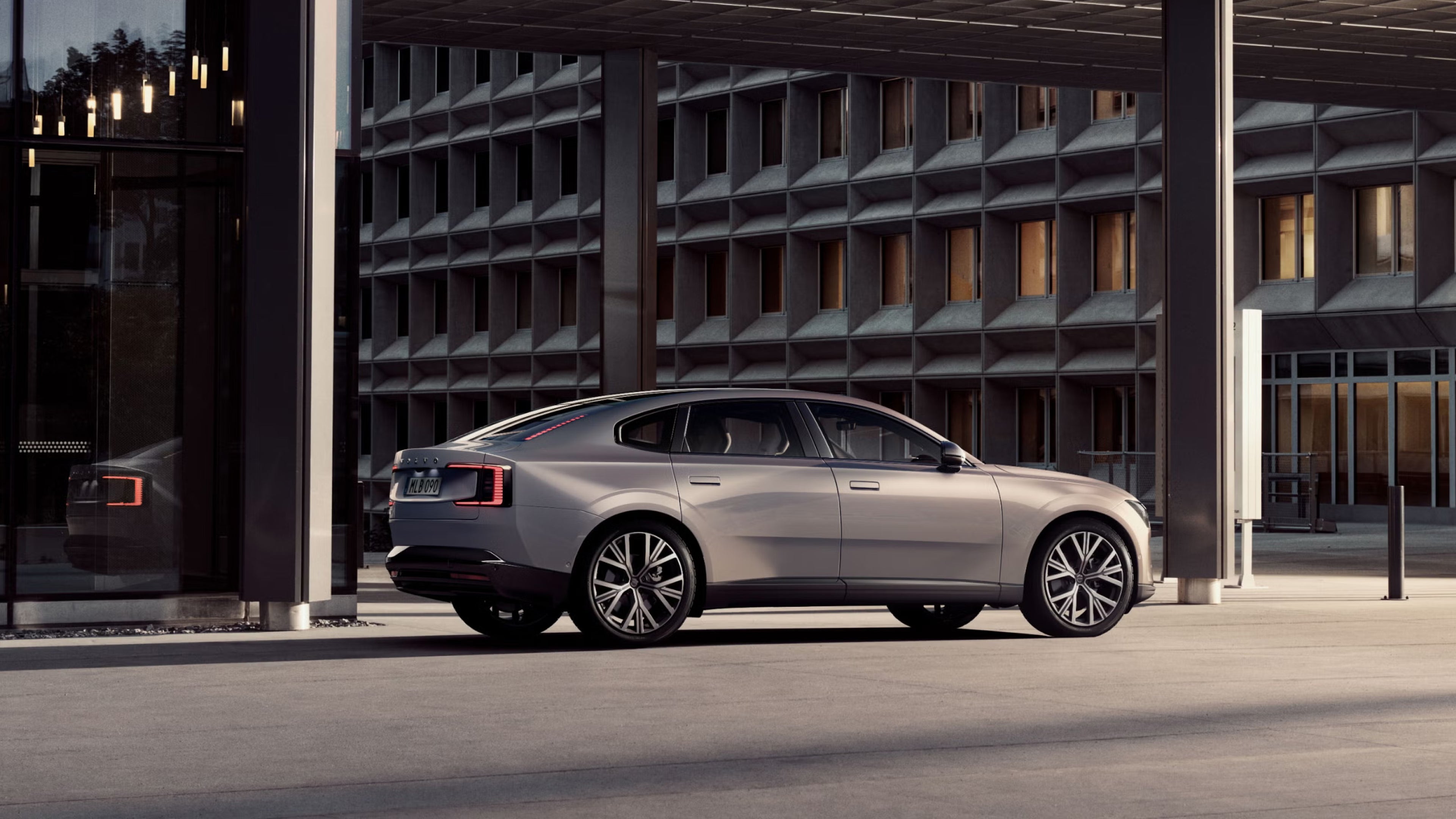 Side view of ES90 in front of geometric building in soft sunlight