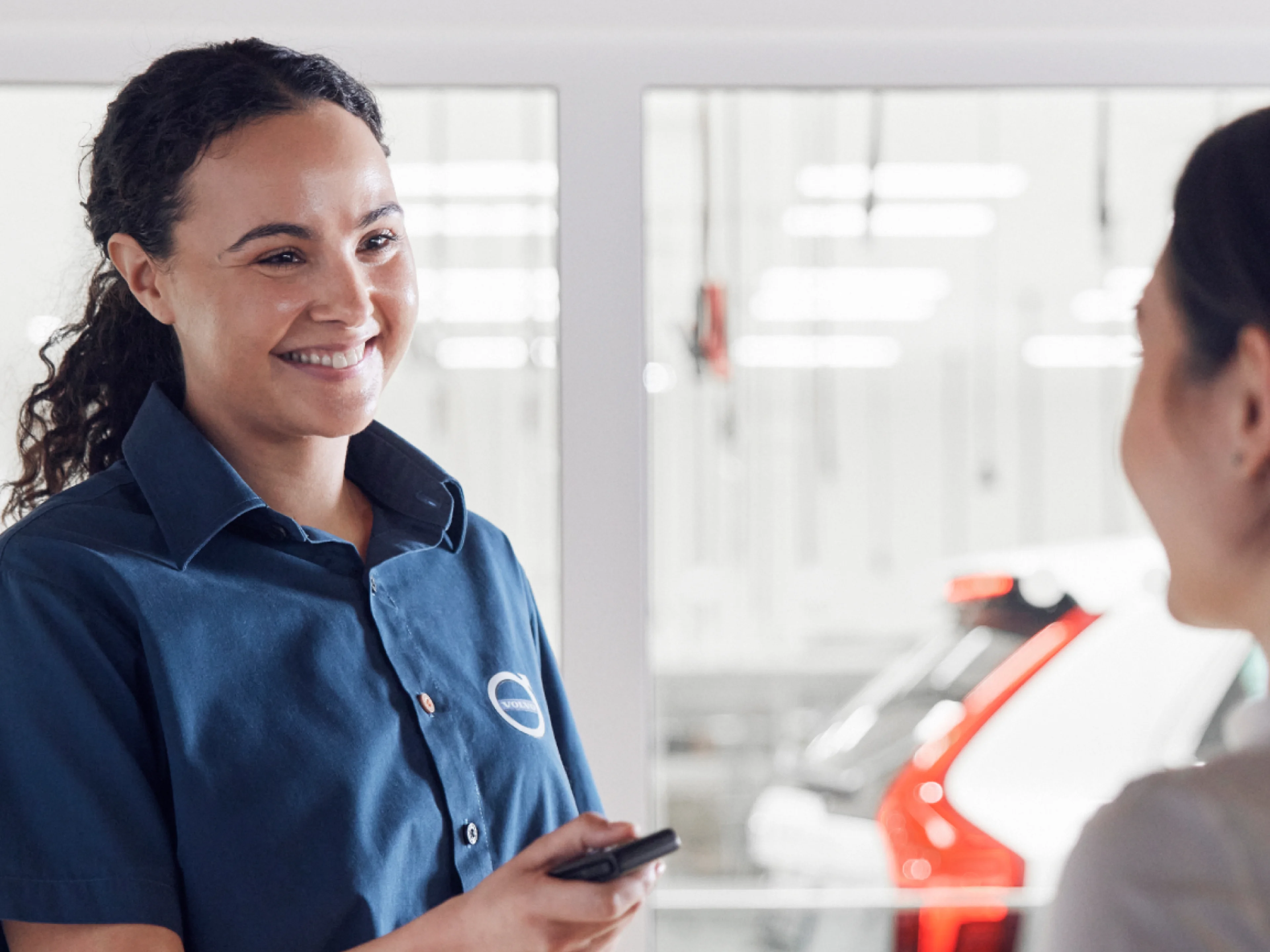 Volvo service technician talking to a customer