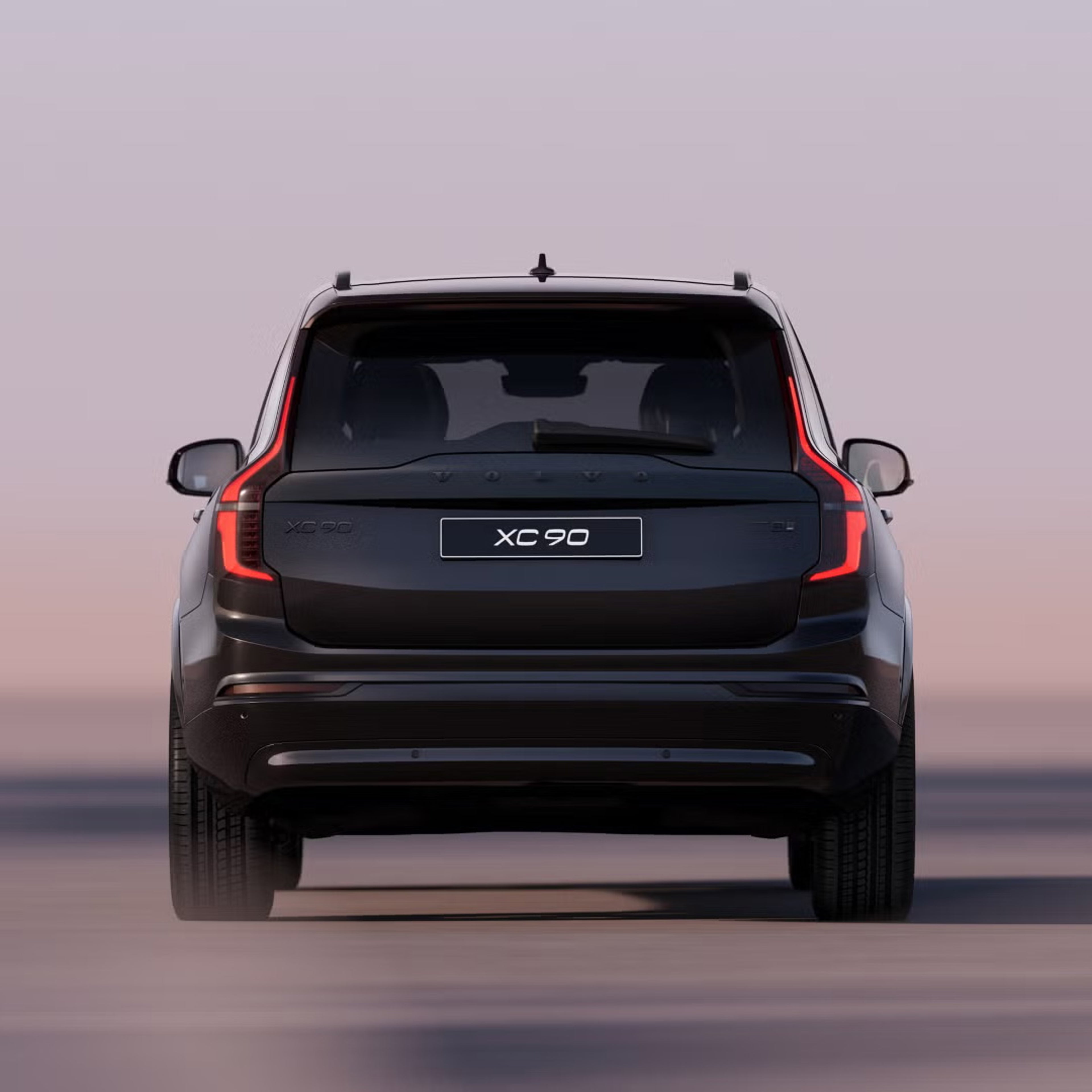Rear view of XC90 plug-in hybrid black edition with pastel sunset background