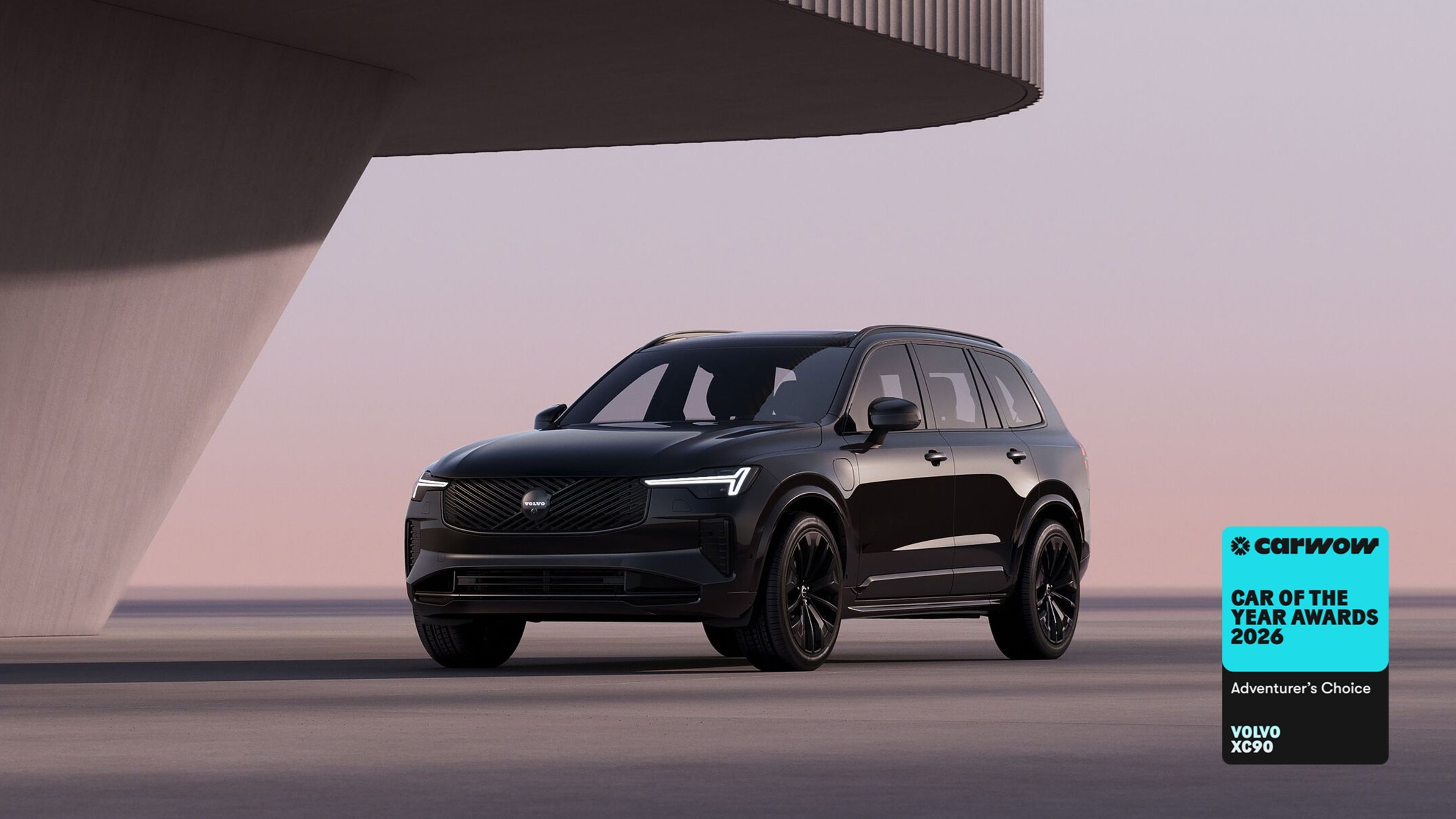 Side view of XC90 plug-in hybrid black edition on pastel background