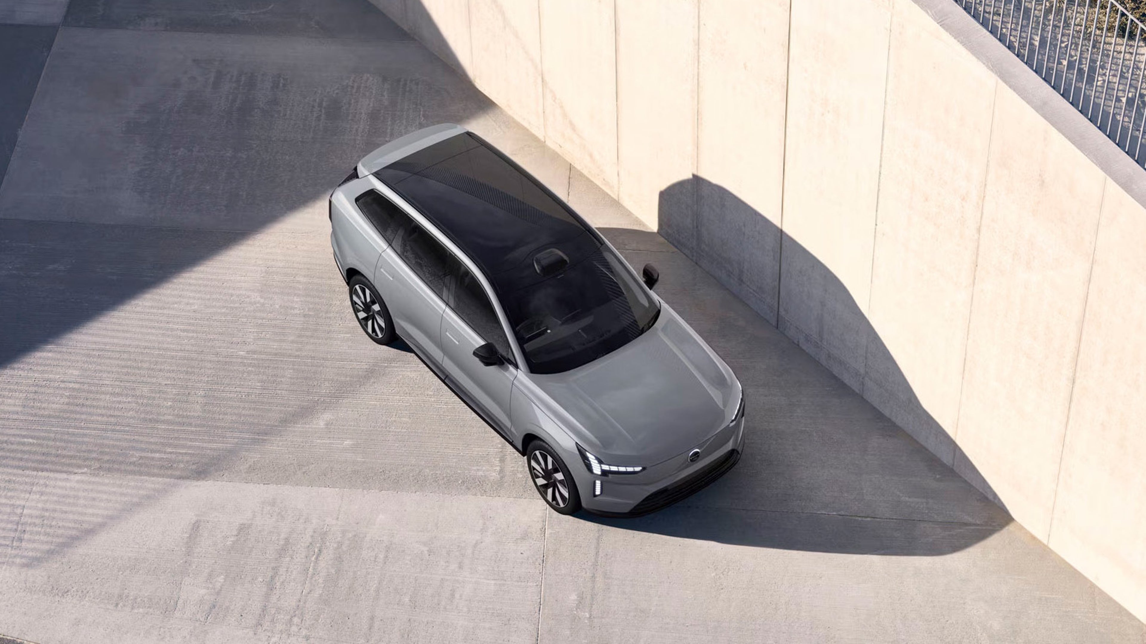 Birds eye view of EX90 car parked against a wall on a sunny day