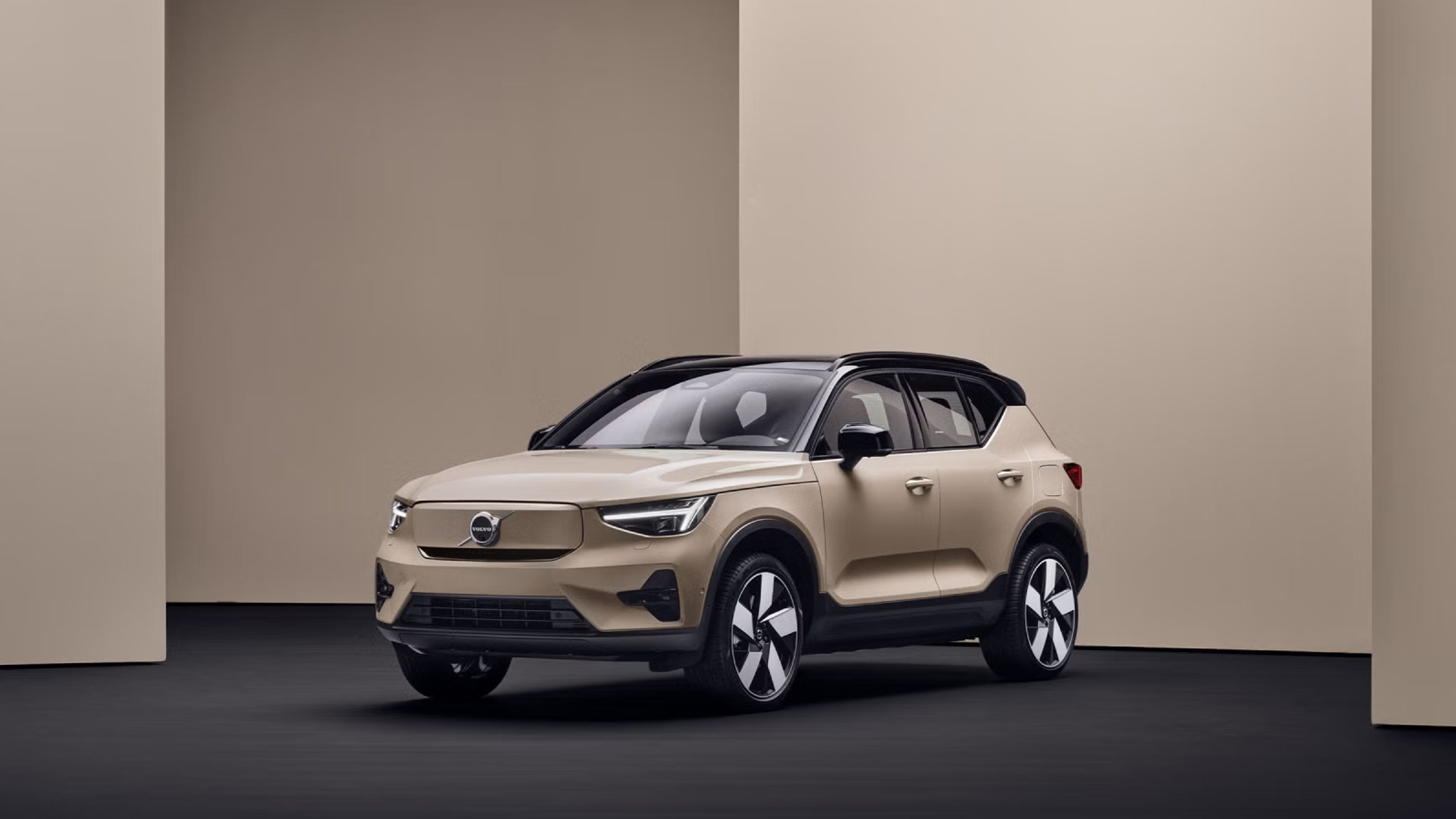 EX40 at three quarter angle against sand colour geometric background on black surface