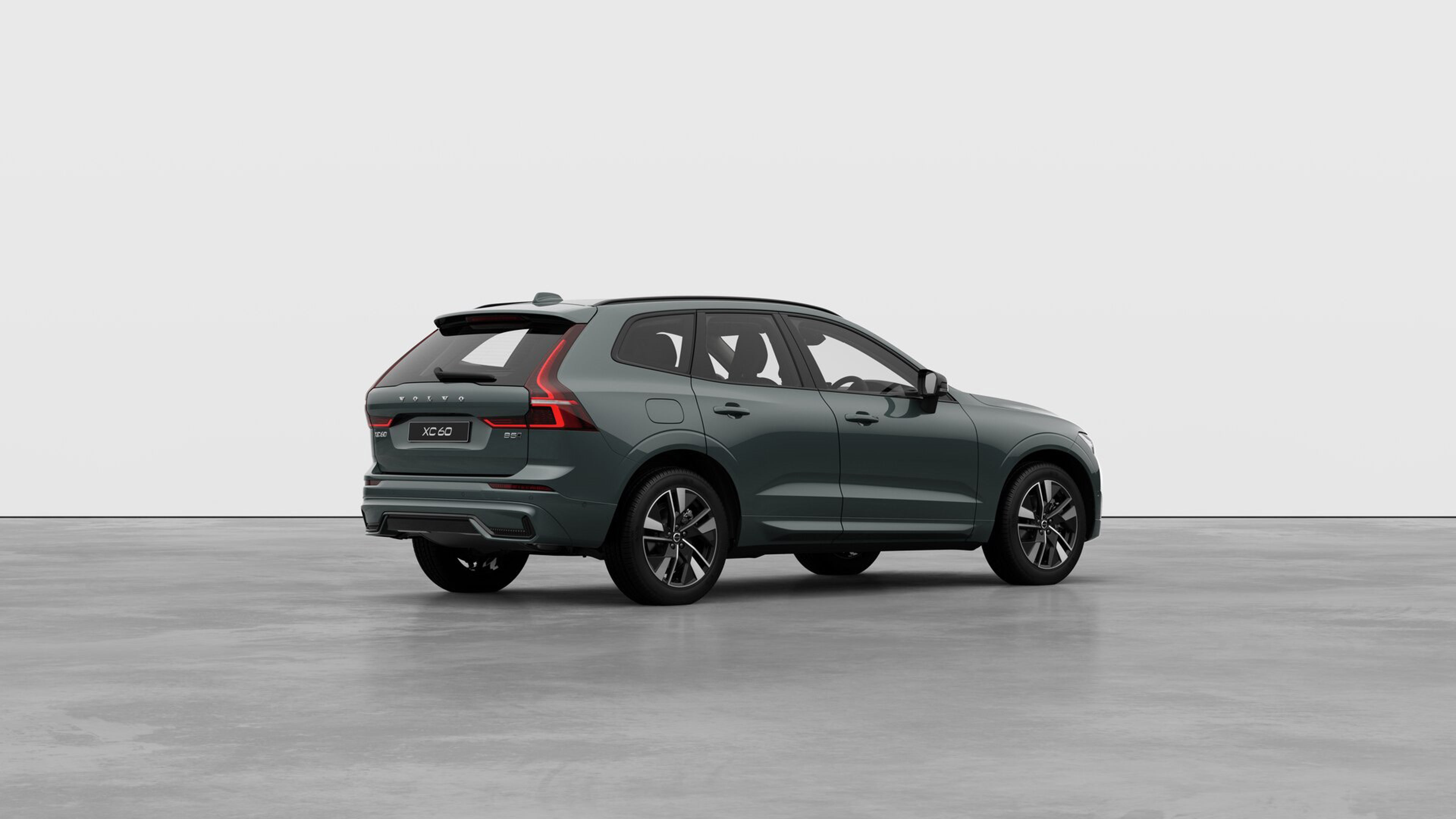 Three quarter view of a XC60 against a plain grey concrete wall