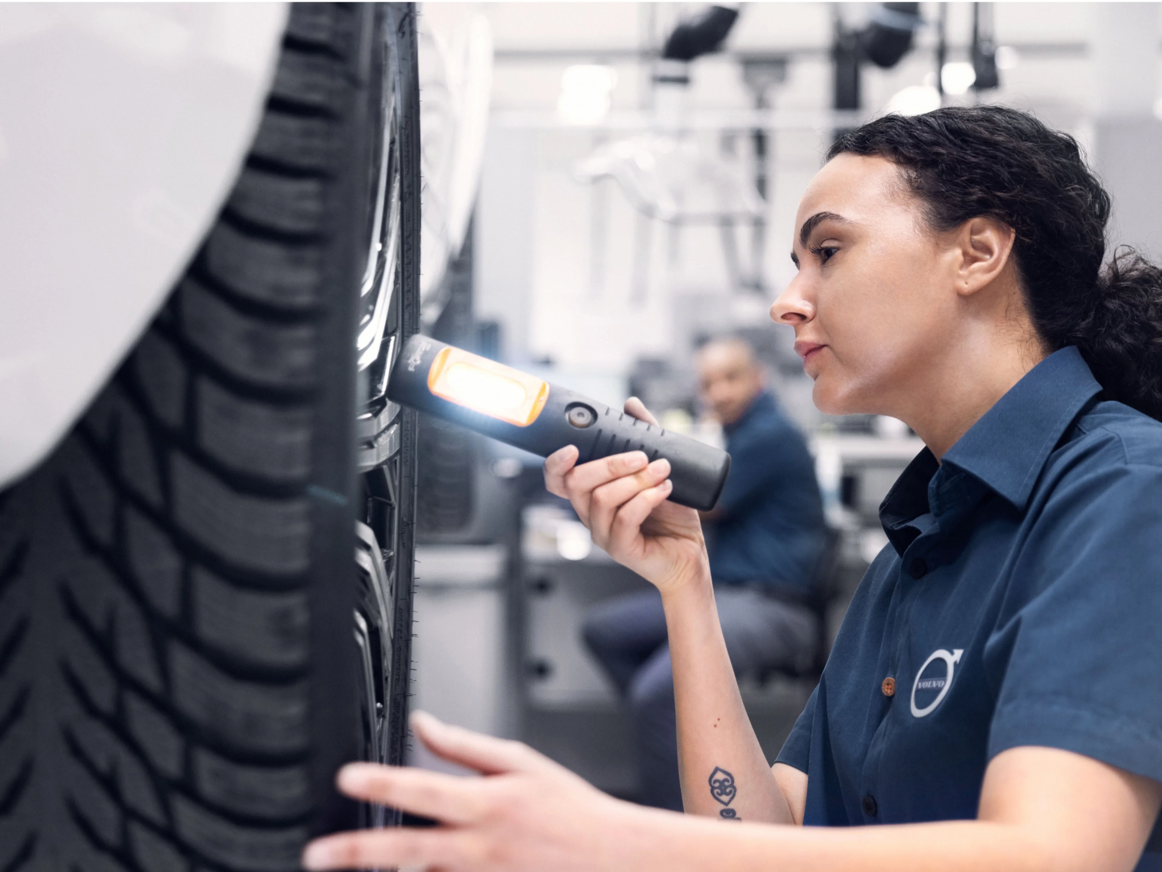 Volvo service technician inspecting a tyre
