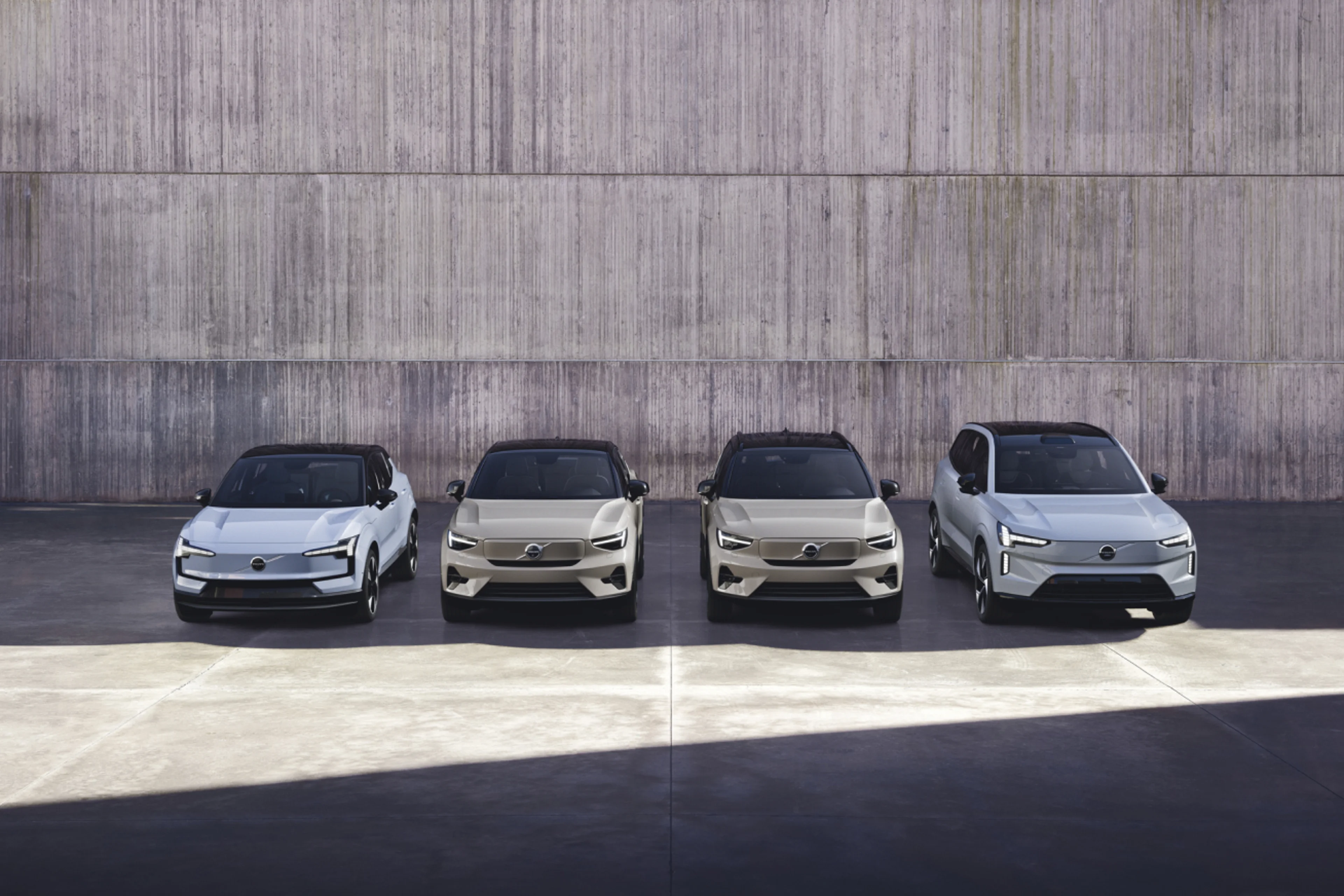 Front view of four electric cars parking in parallel