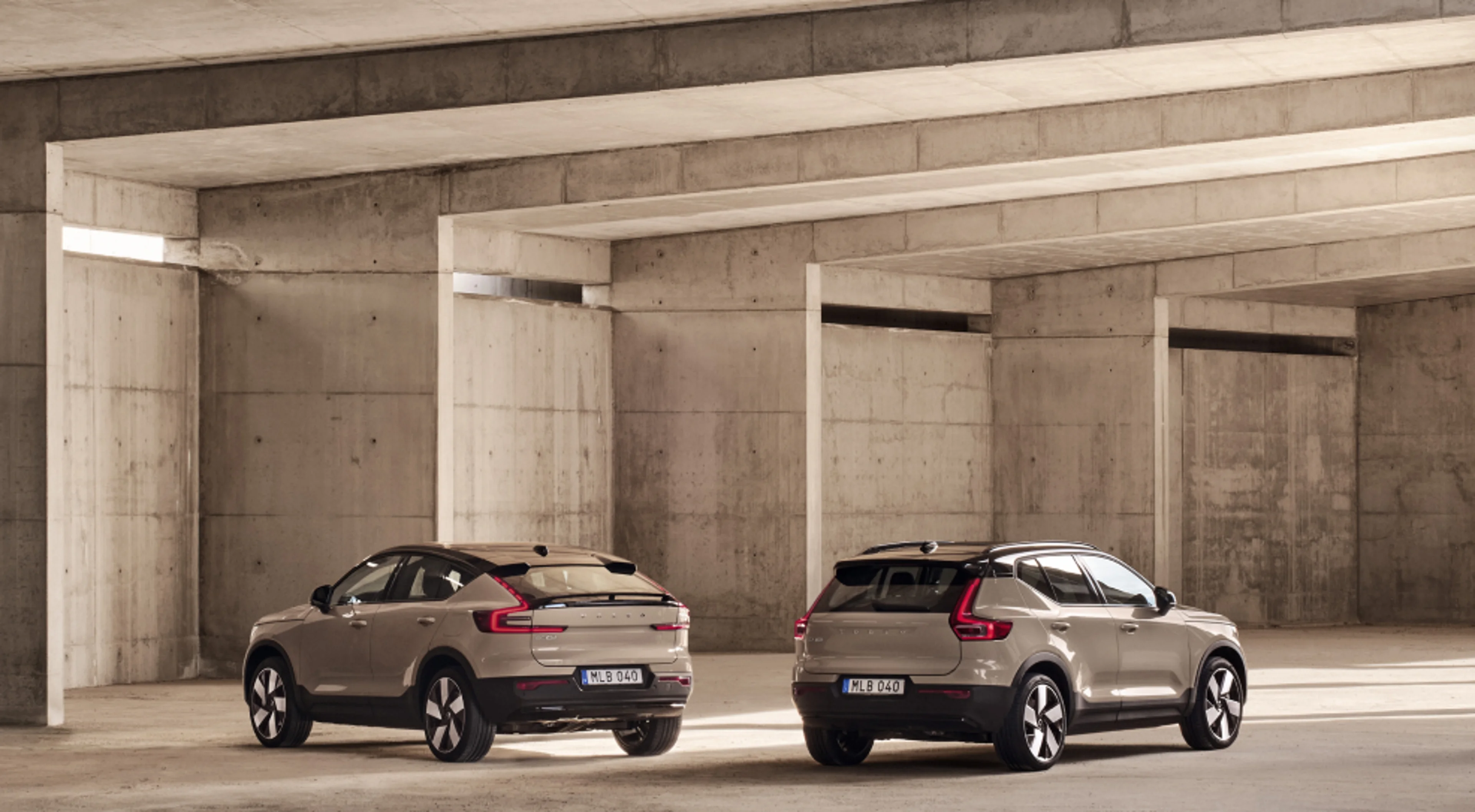 Rear view of two car parking in parallel