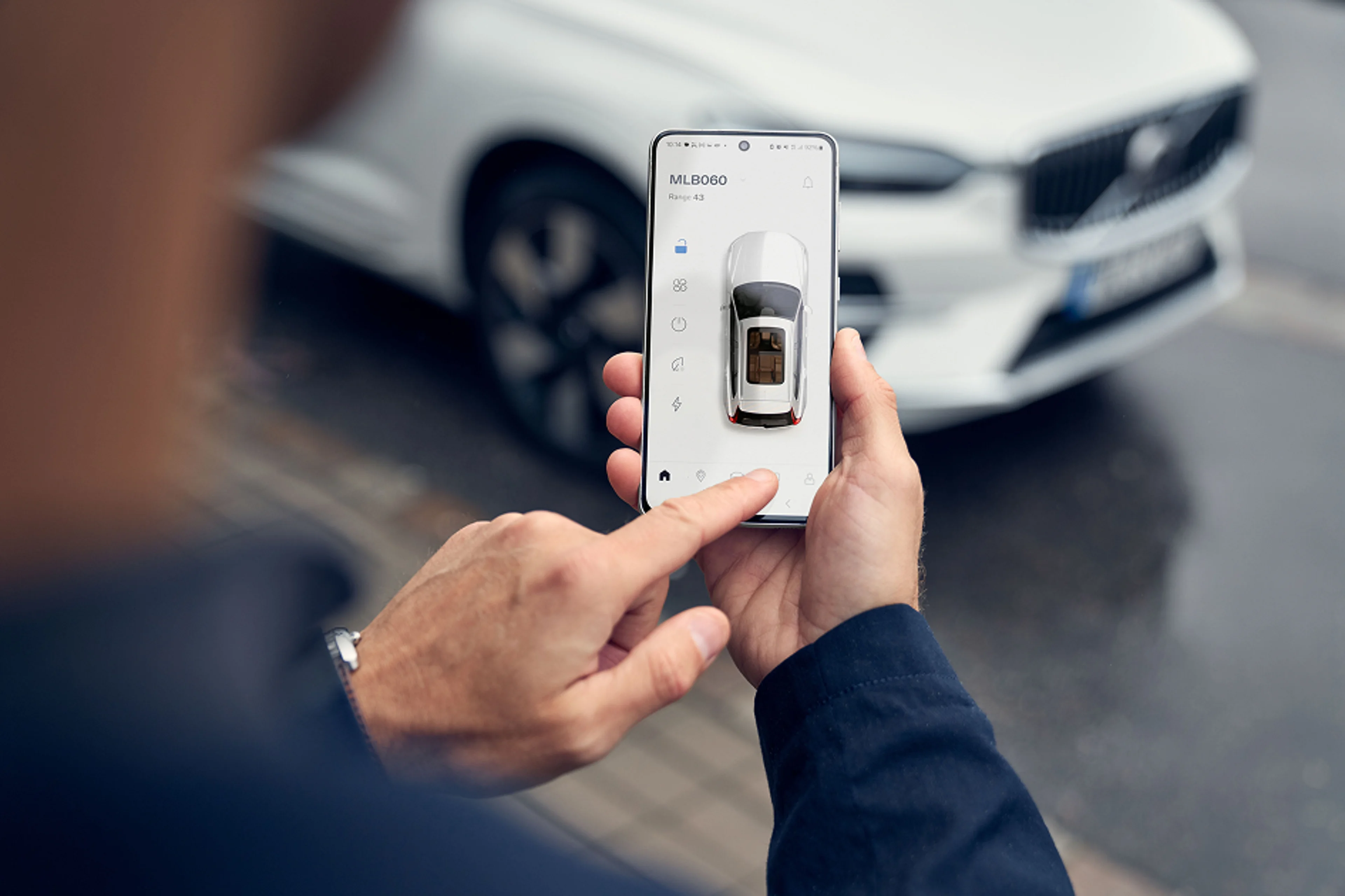 A person is using the Volvo app on his phone