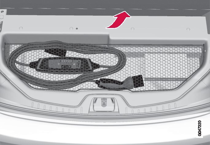 The charging cable is located in the storage compartment under the cargo area's floor cover.