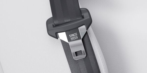 Close-up of a Volvo seatbelt with the text 'since 1959' engraved on the metal.