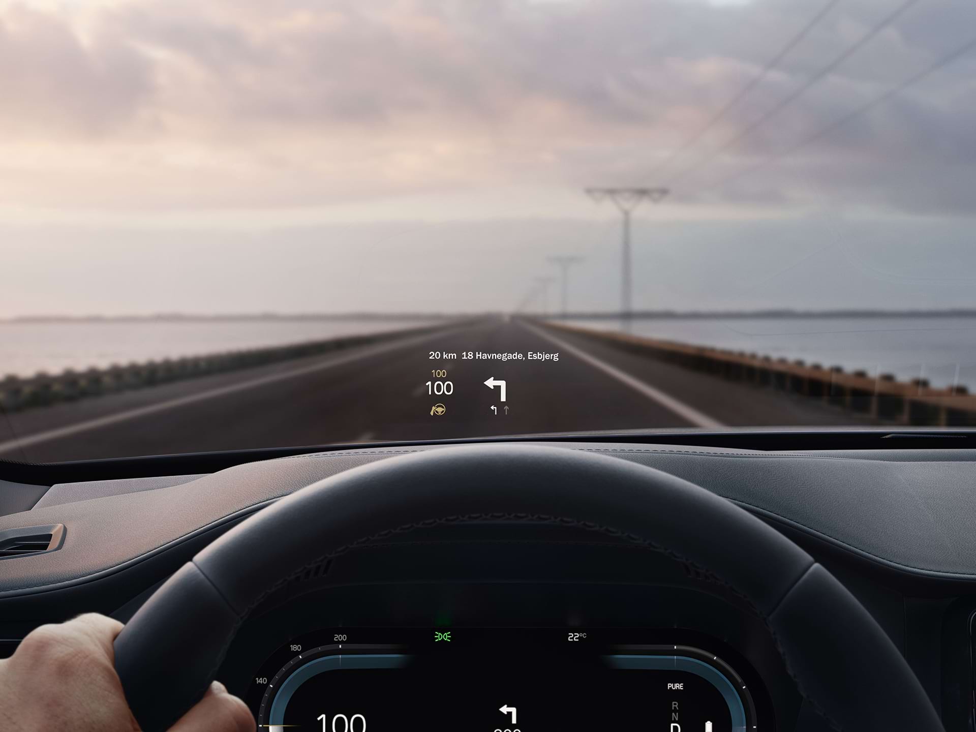 A driver's view of the head-up display appearing on the windshield of their Volvo car.