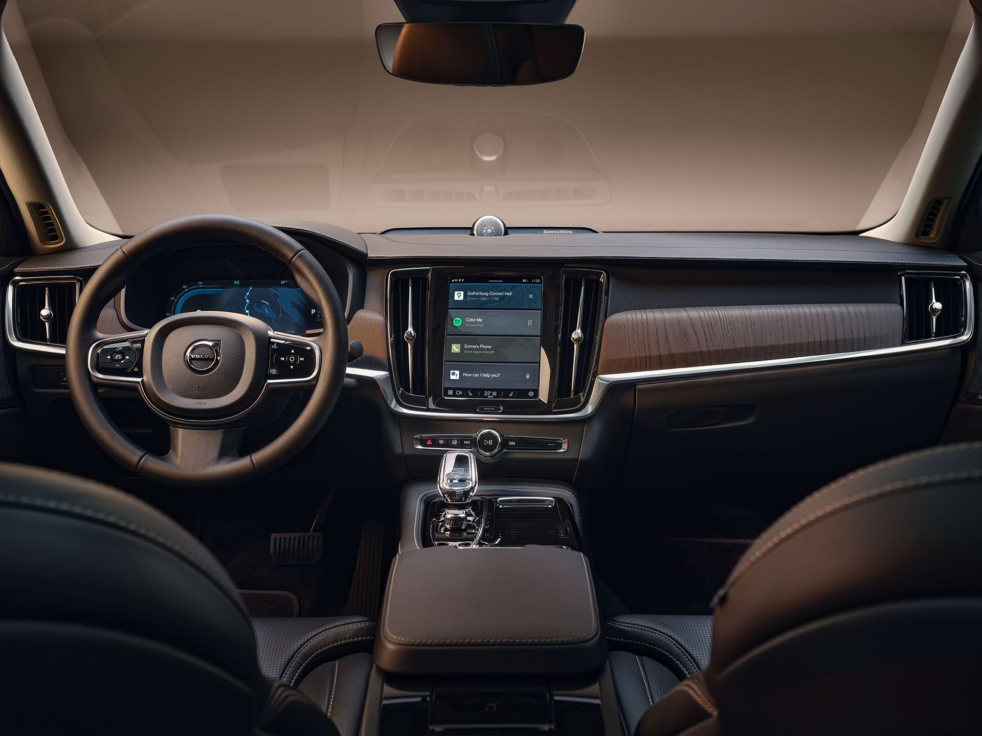 The dashboard, centre display, gear shifter, driver display and steering wheel of a Volvo sedan car.