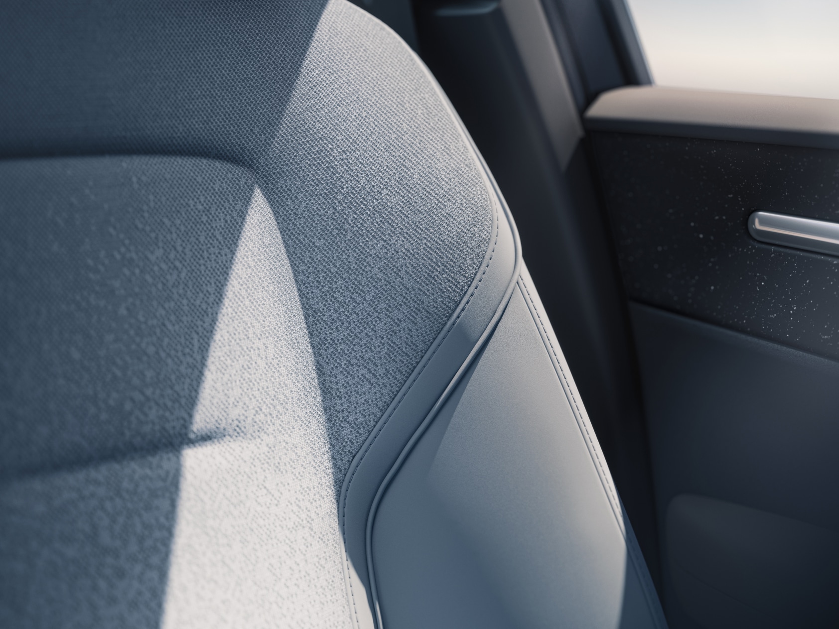 Detailní pohled na čalounění předních sedadel vozu Volvo EX30 v interiéru s designovým motivem Breeze.