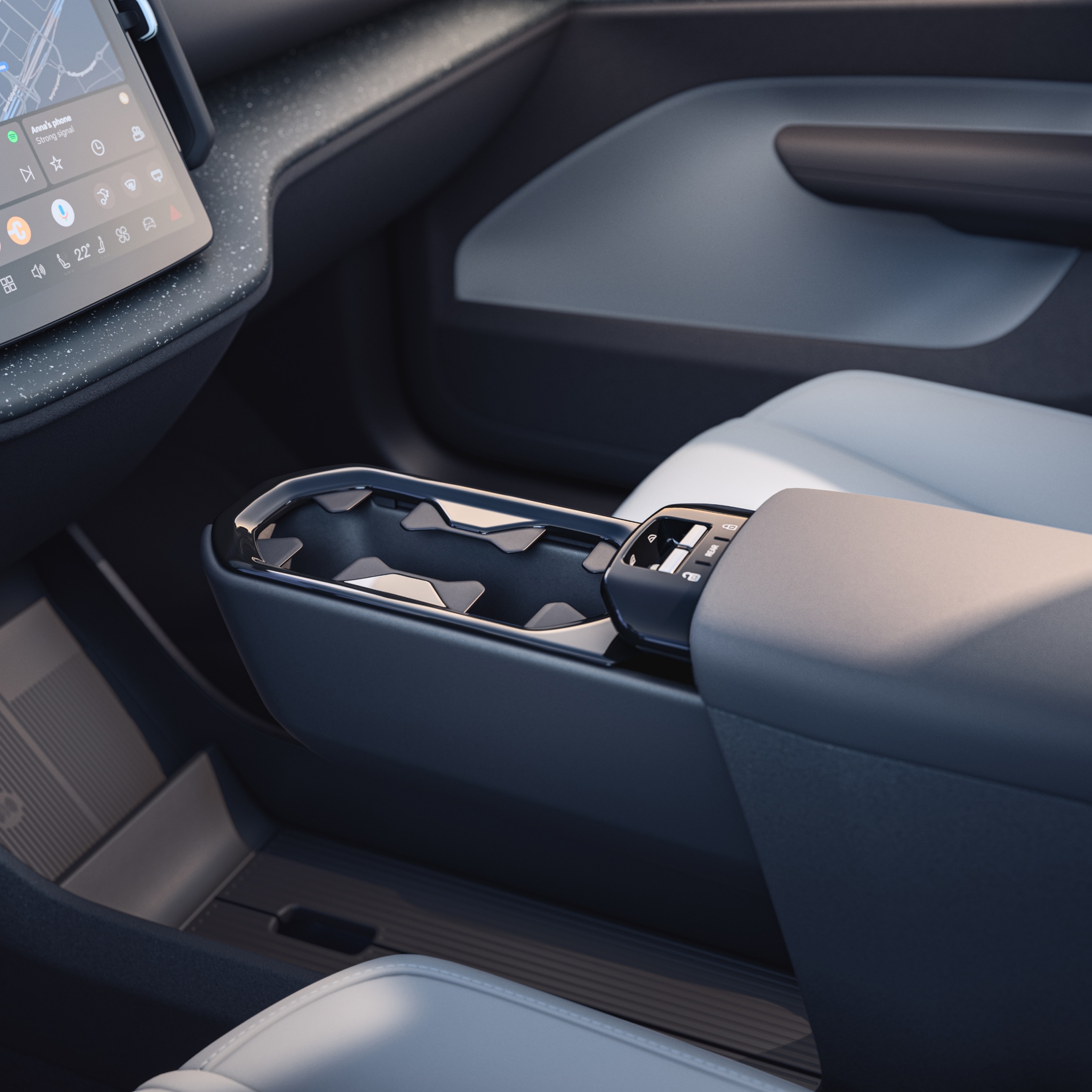 Pohled zblízka na inovativní víceúčelový úložný prostor a držák nápojů ve voze Volvo EX30.