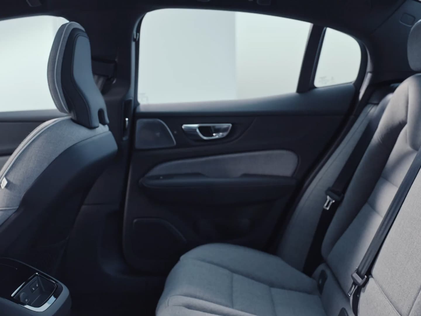 The Volvo S60 Recharge plug-in hybrid’s textile upholstered split-folding back passenger seats and rear center console.