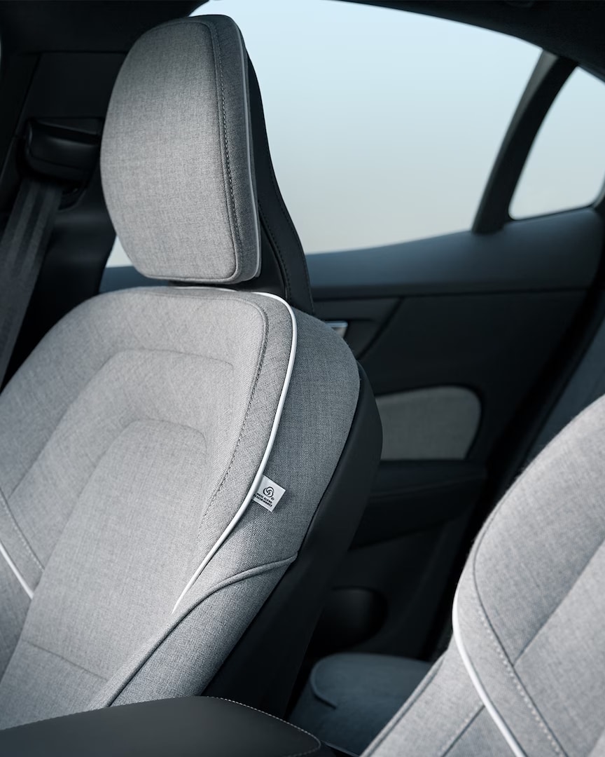 The Volvo S60 Recharge plug-in hybrid’s front passenger and driver’s seats in gray Tailored Wool Blend upholstery with white trim.