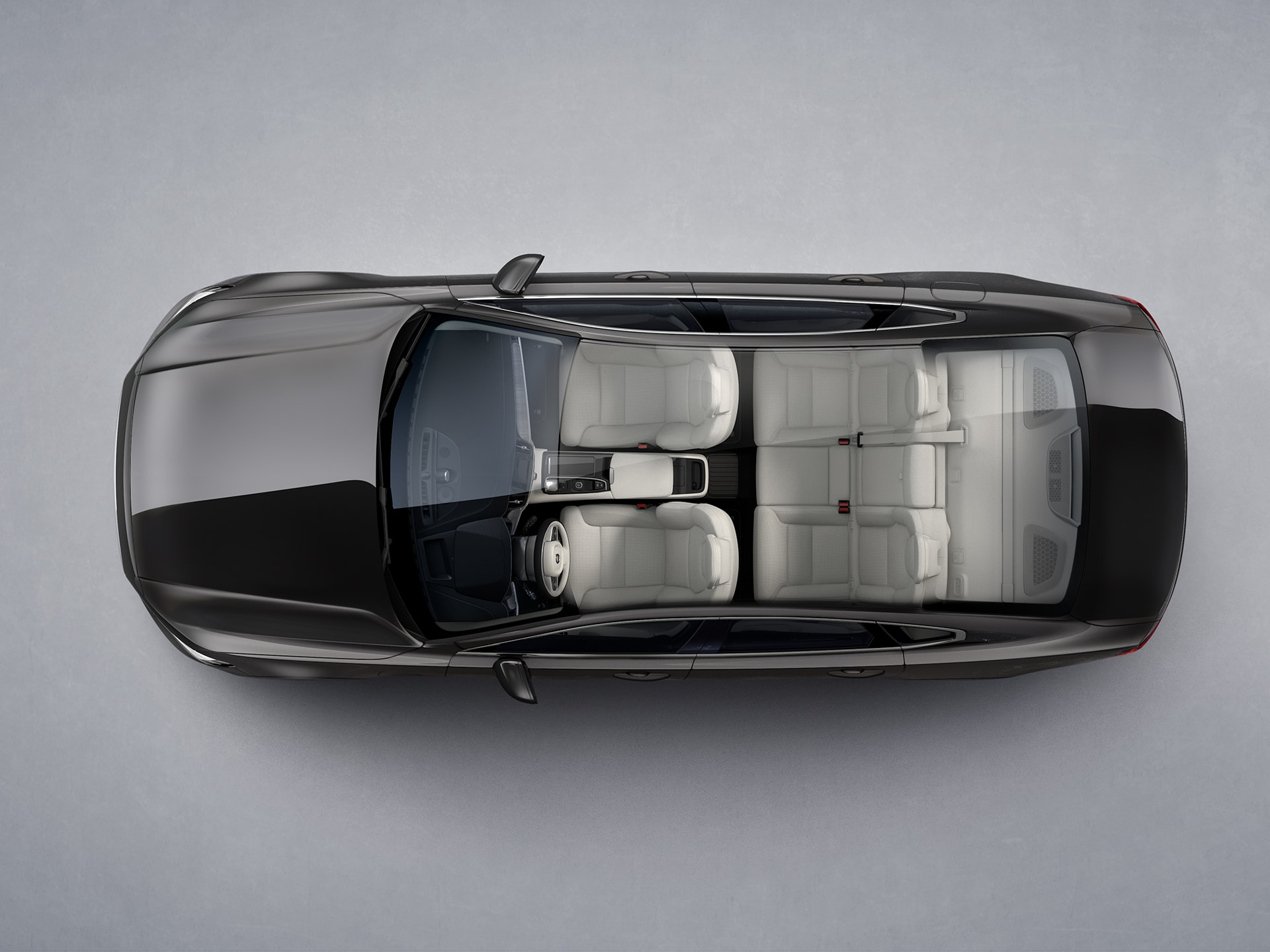 A white Volvo S90 Recharge seen from directly above with interior visible.