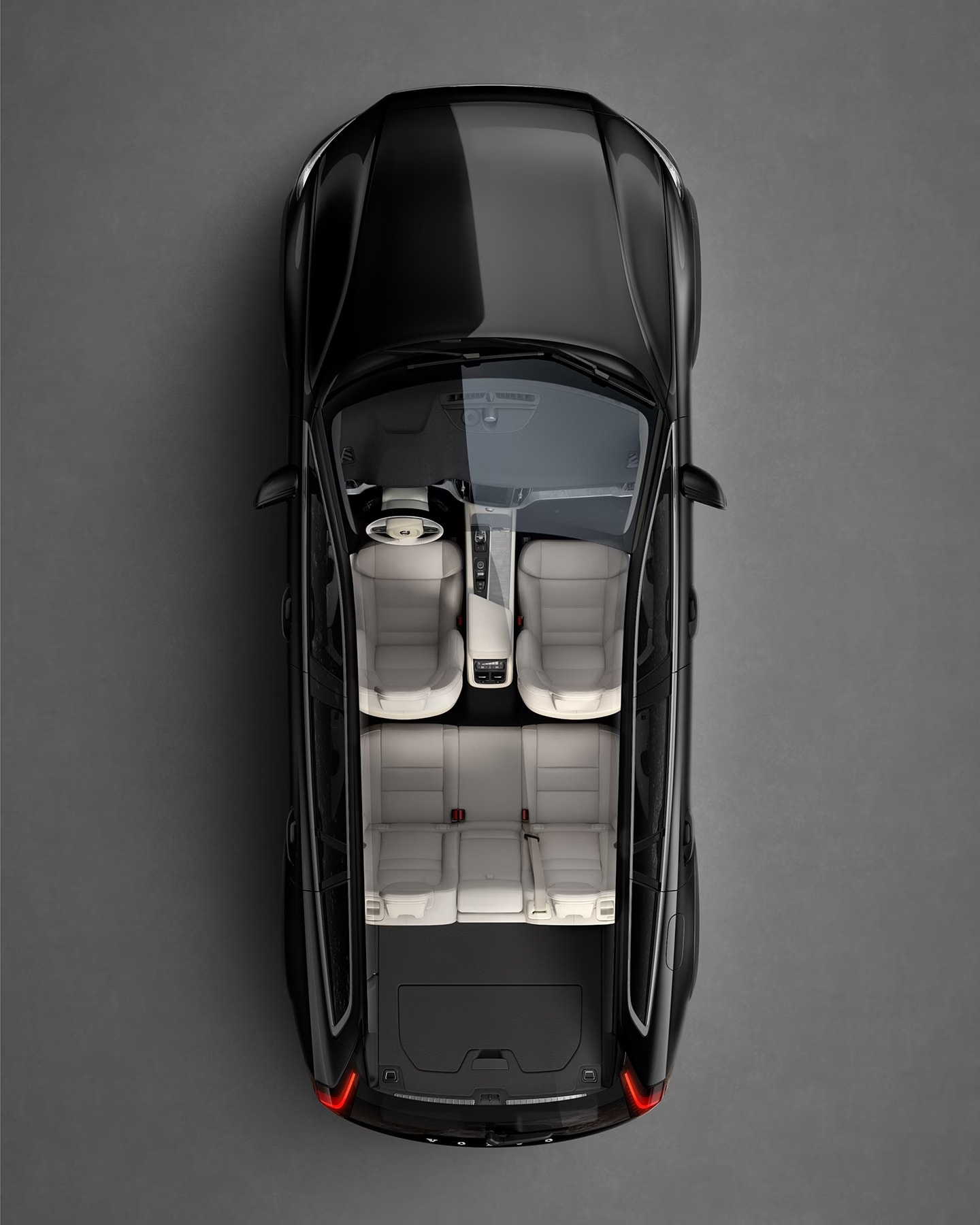 A black Volvo V60 cross country seen from directly above with interior visible.