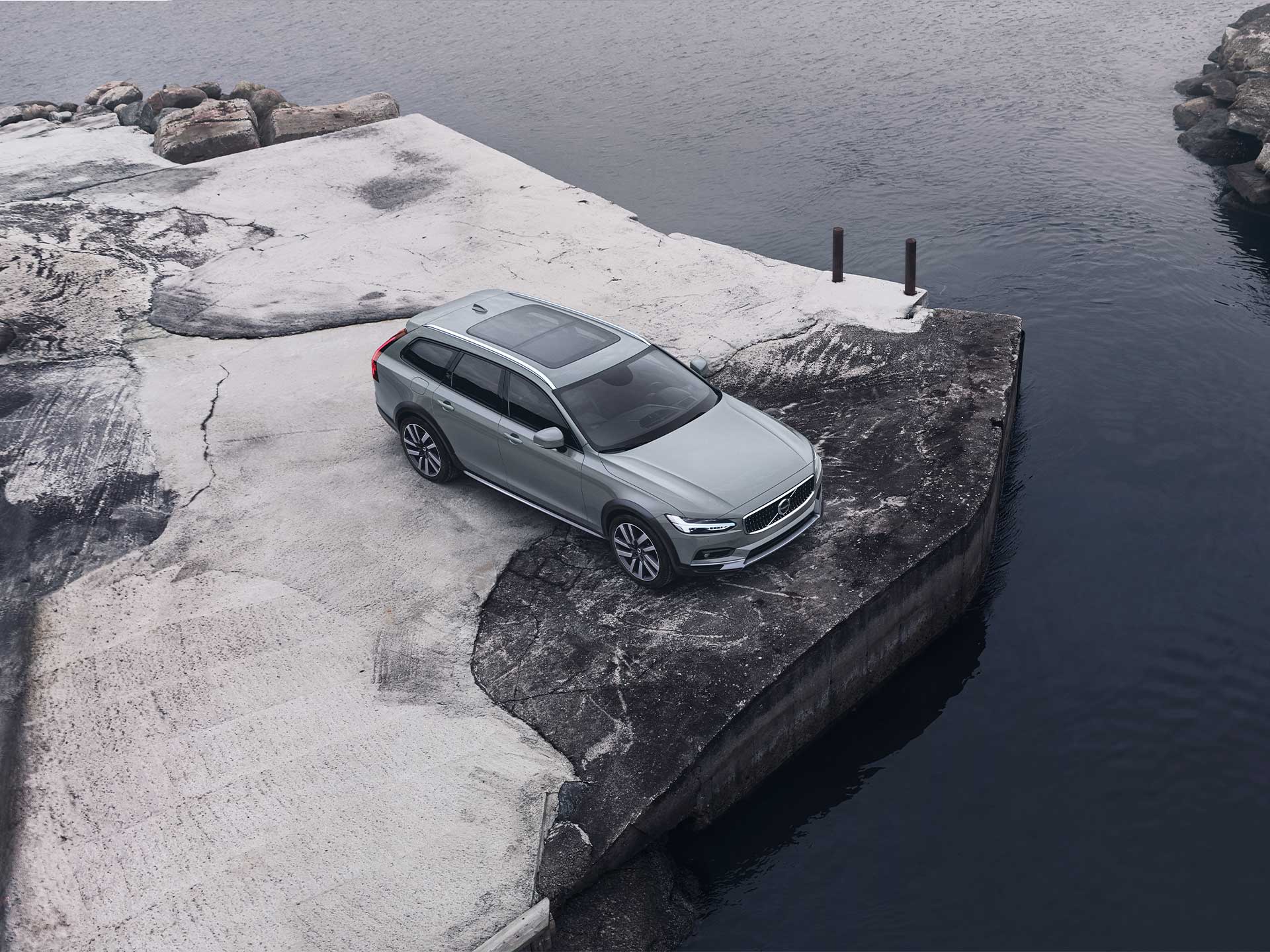 Мягкий гибрид Volvo V90 Cross Country едет по горной дороге.