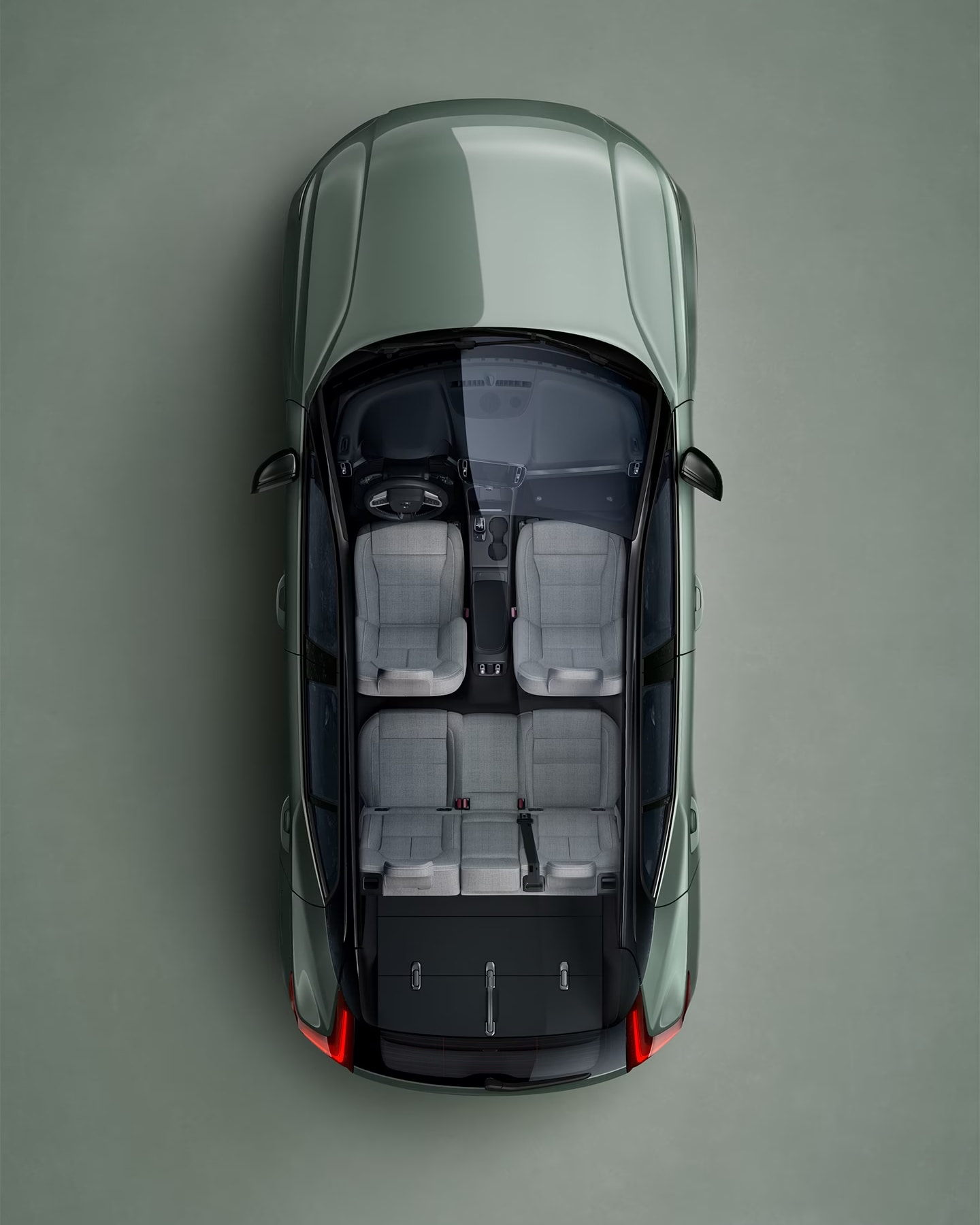 A green Volvo XC40 Recharge seen from directly above with interior visible.