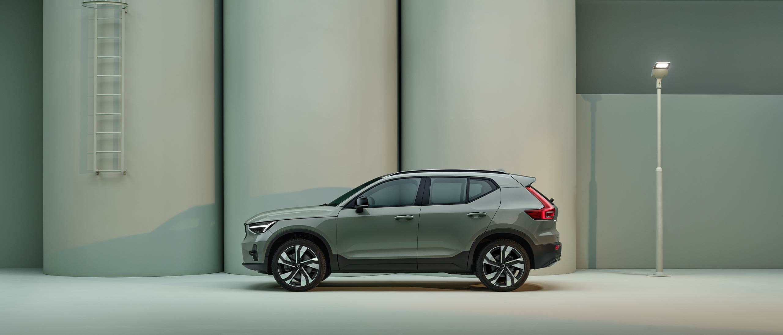 The side profile of a green Volvo XC40 SUV.