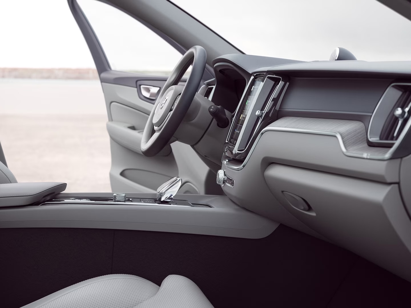 Front interior of Volvo XC60 with driver door open.