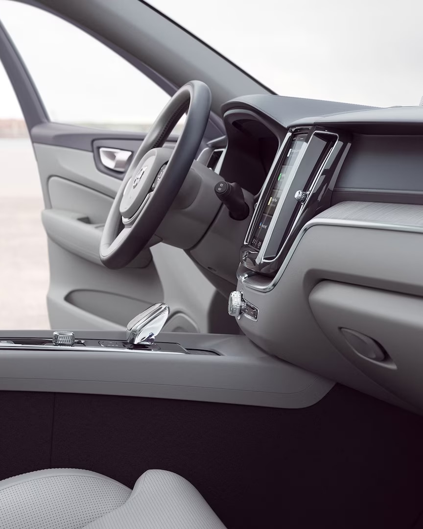 Front interior of the Volvo XC60 with driver door open.